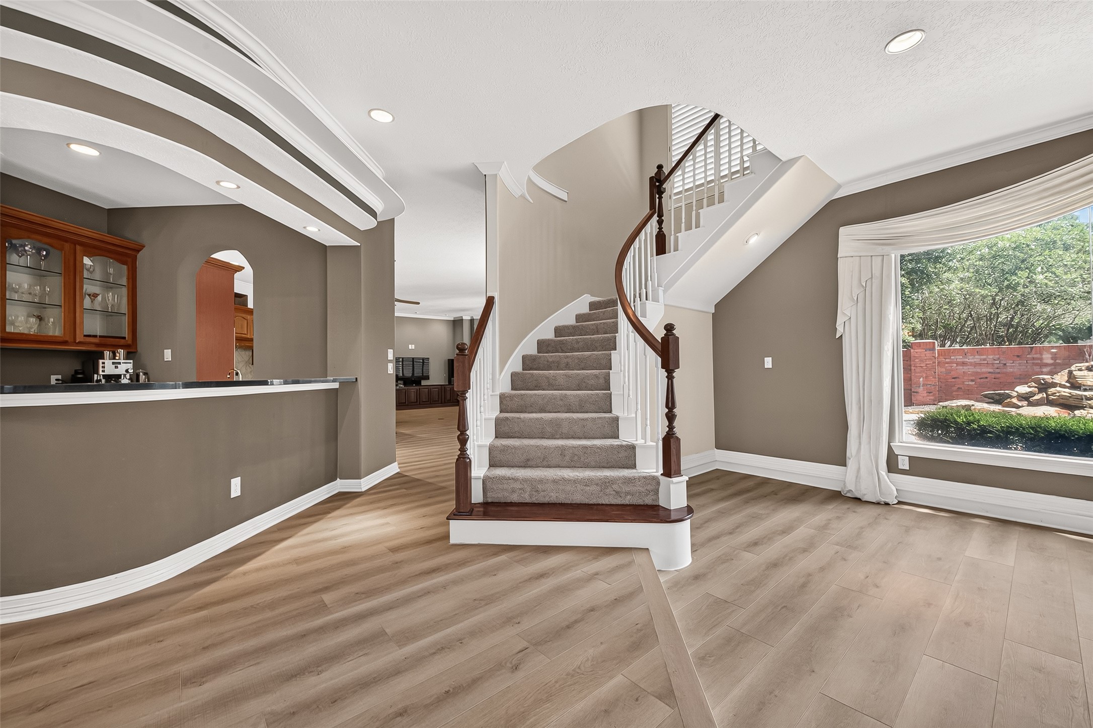 Beautiful LVP flooring throughout, amazing open-concept floor plan, wet bar, and a statement-making grand staircase, the list of things to love about this home goes on and on!