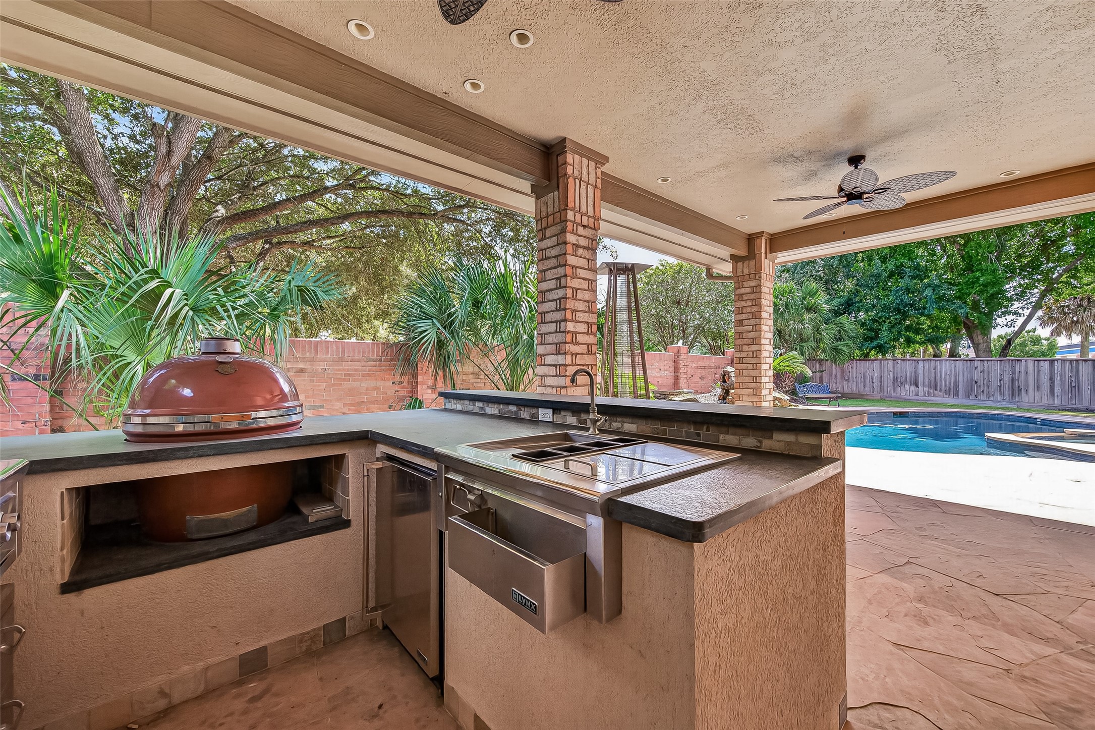 Amazing outdoor kitchen complete with a grill, smoker, wok burner, sink, and beverage fridge!