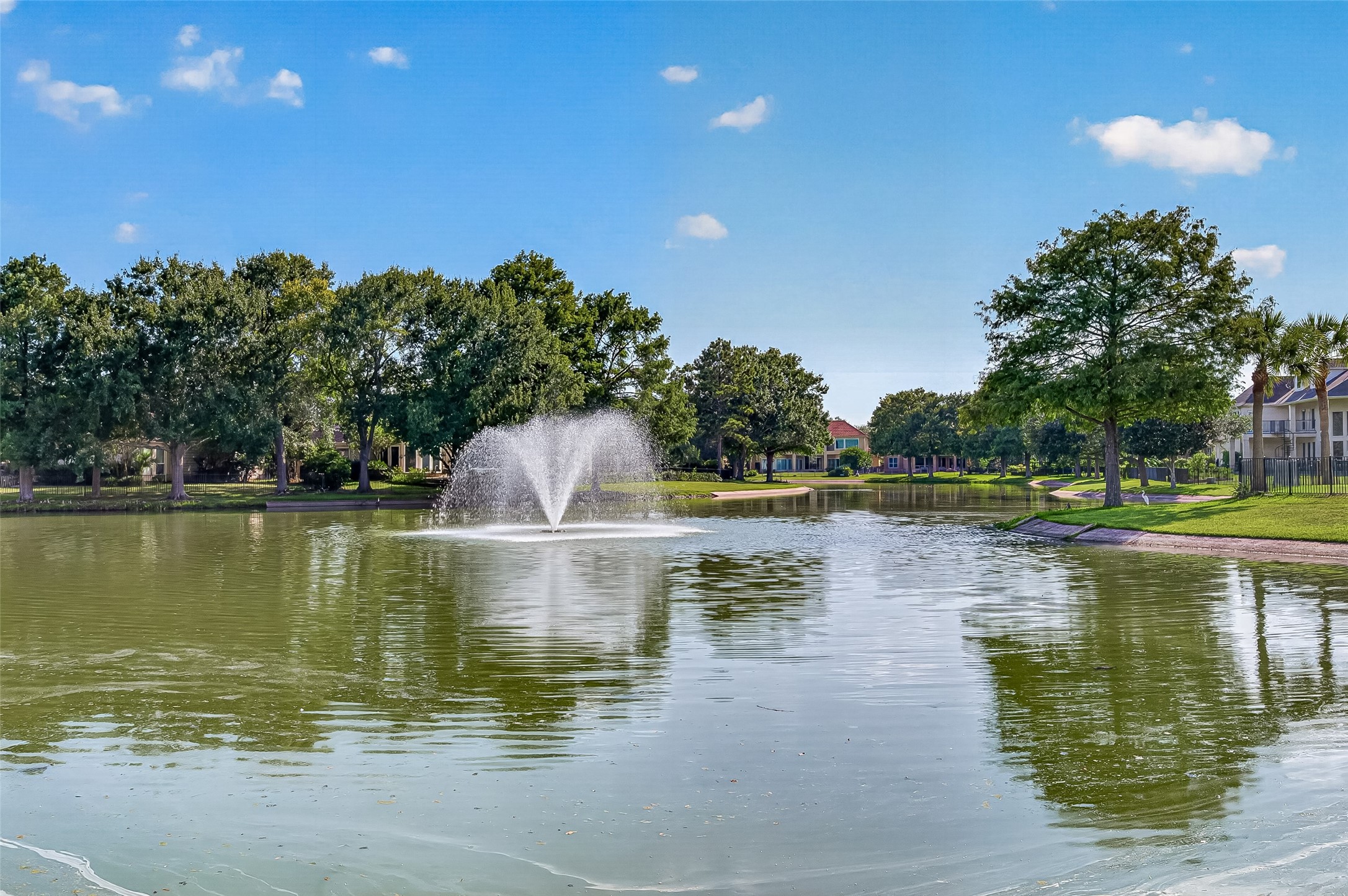 Serene lake view with a central fountain welcomes you as you enter the gates of Pointe Royale