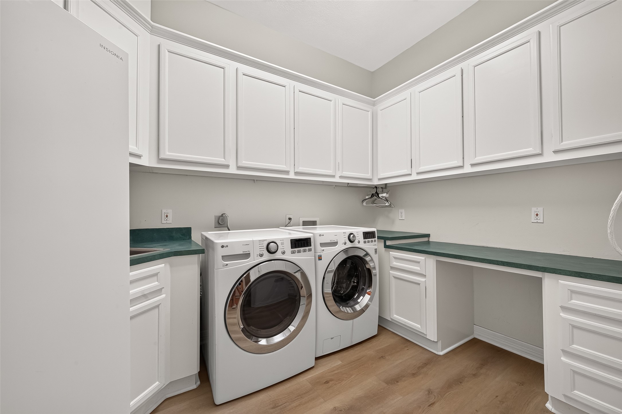 Doing laundry is a breeze in a space like this, complete with a sink, plenty of cabinets for storage, and folding counter.