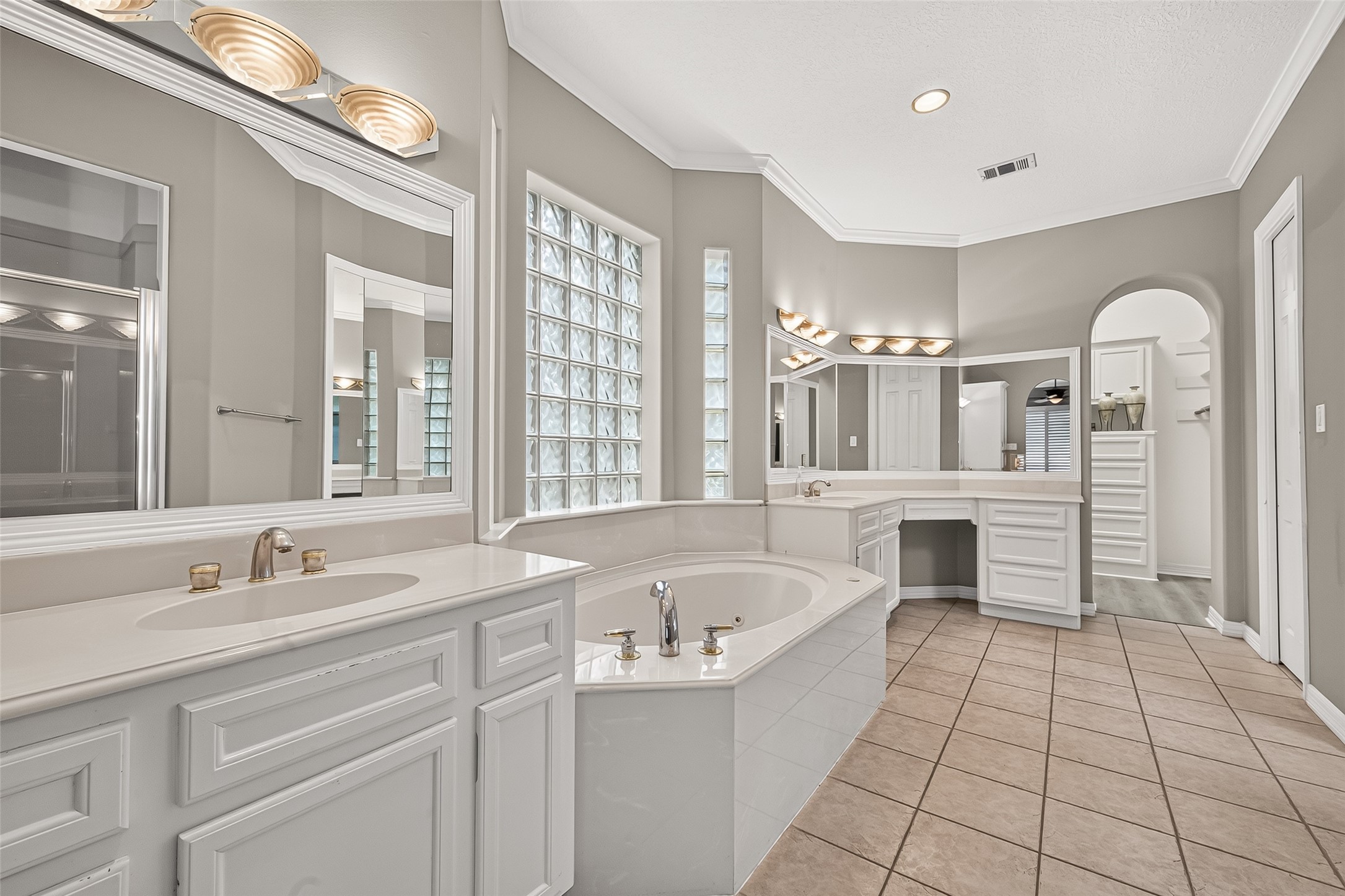 Spacious owner's bathroom featuring a soaking tub, dual vanities, double shower and two separate closets!
