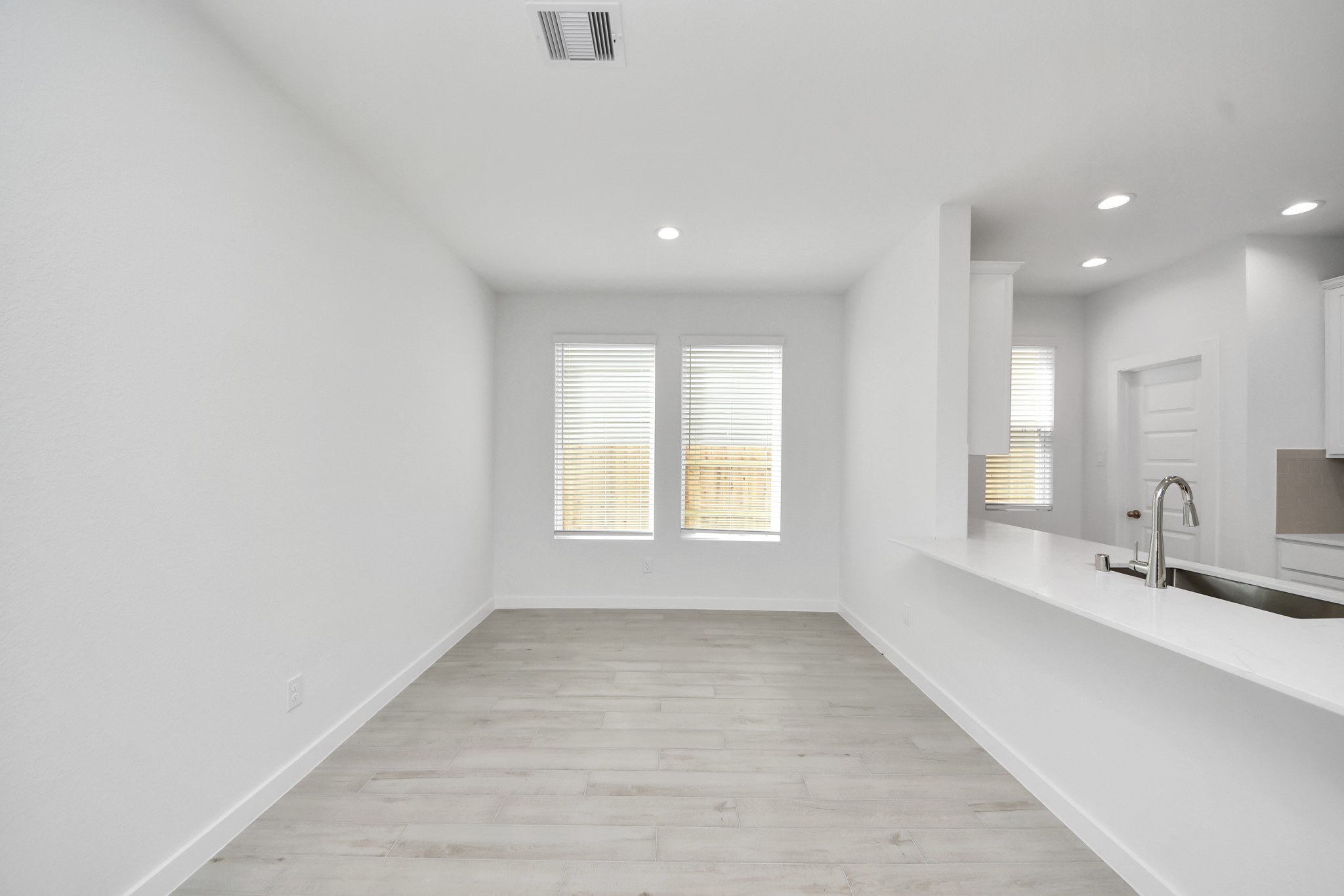 Make memories gathered around the table with your family and friends! This spacious dining room features elegant flooring, custom paint, and adjacent to family room and kitchen for open concept feel. Sample photo of completed home with similar floor plan. Actual colors and selections may vary.