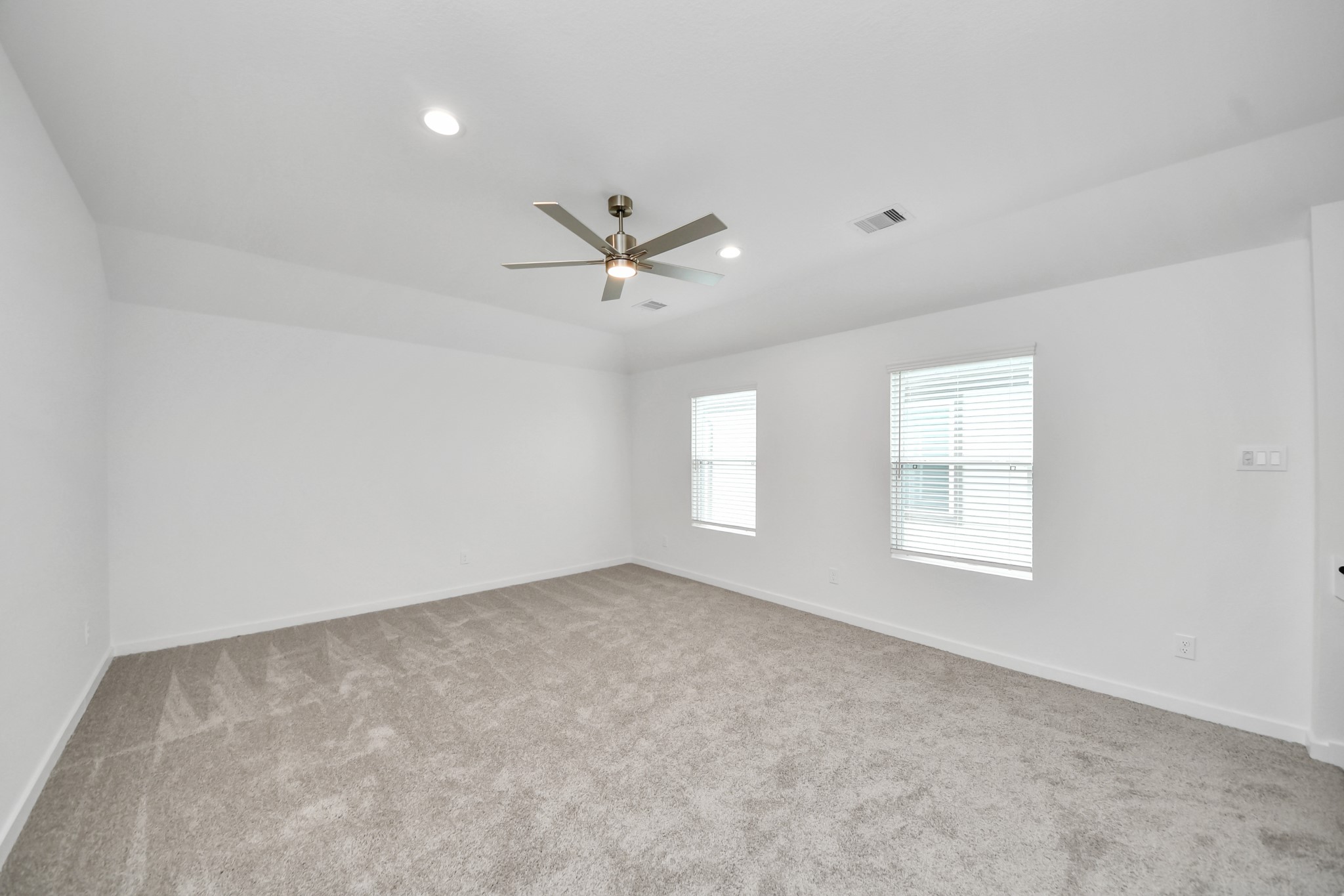 Ascend to relaxation in this fantastic game room! Ideal for both casual gatherings and adult gaming, it boasts plush carpet, lofty ceilings, custom paint, and ample windows for abundant natural light. Sample photo of completed home with similar floor plan. Actual colors and selections may vary.