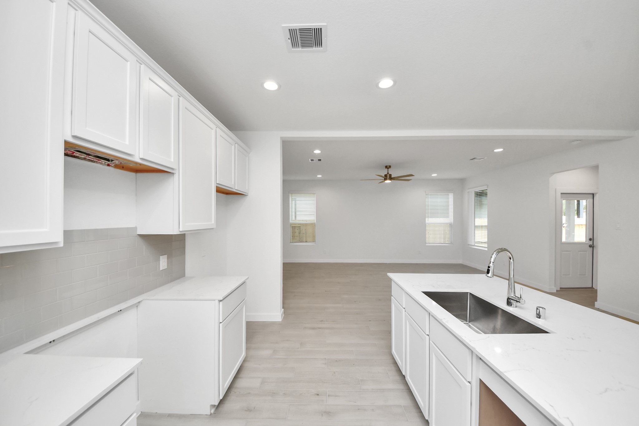 All of this overlooks your expansive family room, creating a perfect space for culinary delights and family gatherings. Sample photo of completed home with similar floor plan. Actual colors and selections may vary.