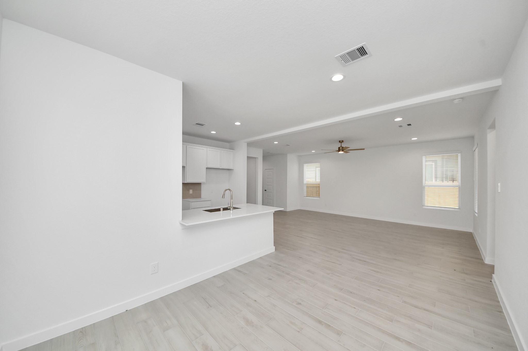 Create lasting memories with your family and friends at the dining table! This expansive dining room showcases sophisticated flooring, custom paint, and seamlessly connects to the family room and kitchen, providing an open and inviting atmosphere. Sample photo of completed home with similar floor plan. Actual colors and selections may vary.