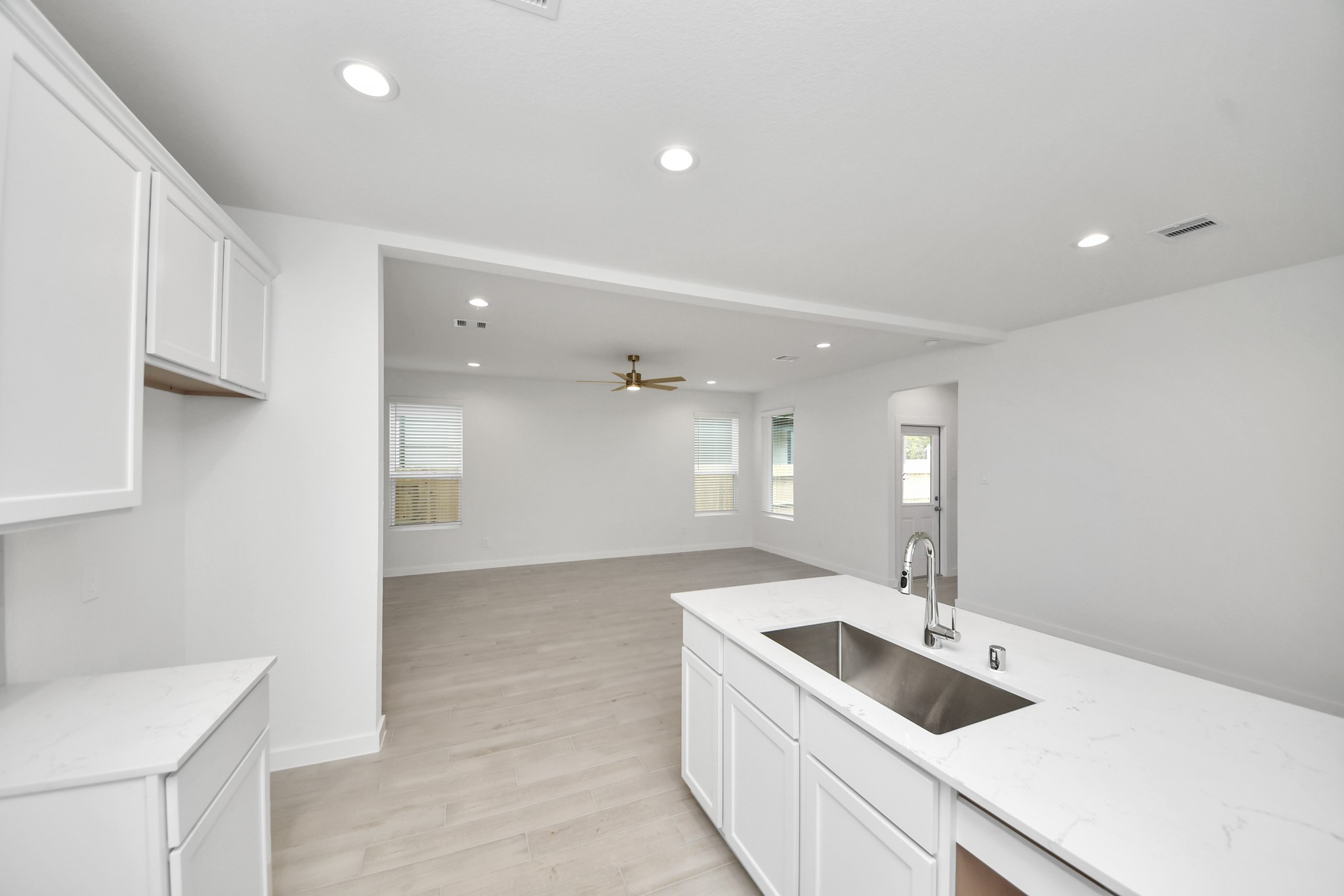 Discover another perspective of this stunning kitchen, generously appointed with an abundance of counter space. Sample photo of completed home with similar floor plan. Actual colors and selections may vary.