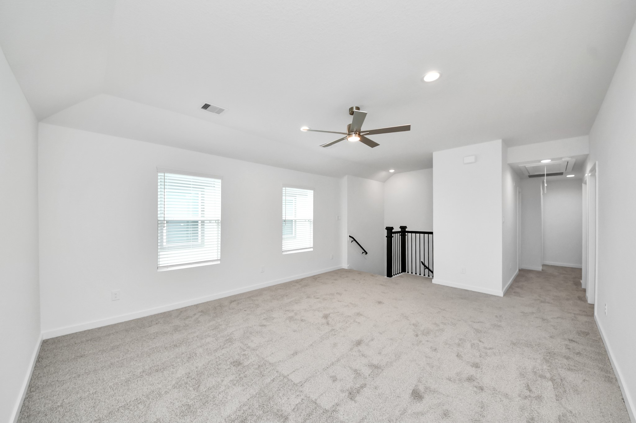 Come upstairs and enjoy a day of leisure in this fabulous game room! This is the perfect hangout spot or adult game room! Features plush carpet, high ceilings, custom paint and windows for plenty of natural light. Sample photo of completed home with similar floor plan. Actual colors and selections may vary.