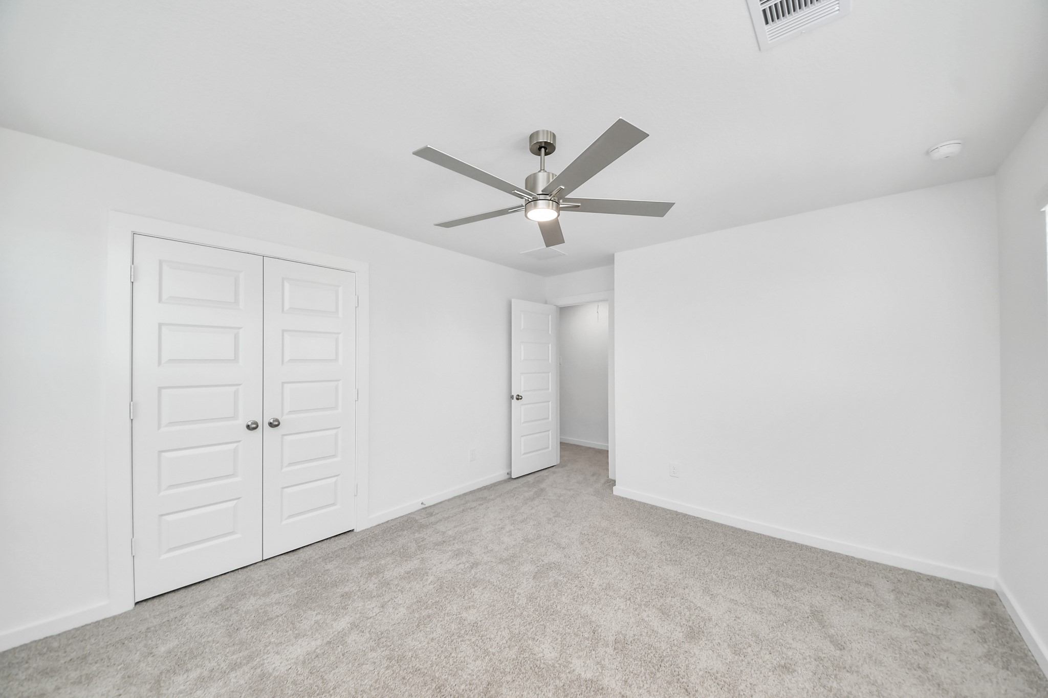 Generously sized secondary bedrooms featuring spacious closets, soft and inviting carpeting underfoot, large windows allowing plenty of natural light, and the added touch of privacy blinds for your personal retreat. Sample photo of completed home with similar floor plan. Actual colors and selections may vary.