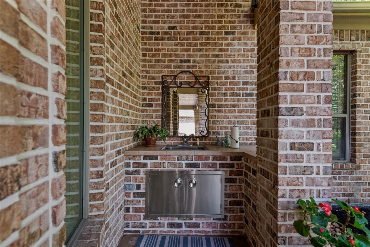 There is a sink tucked away at the back wall of the patio- perfect for cleaning up after grilling or gardening.