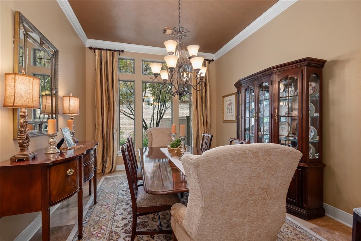 The dining room features an exquisite view of the side patio, pool and landscape.