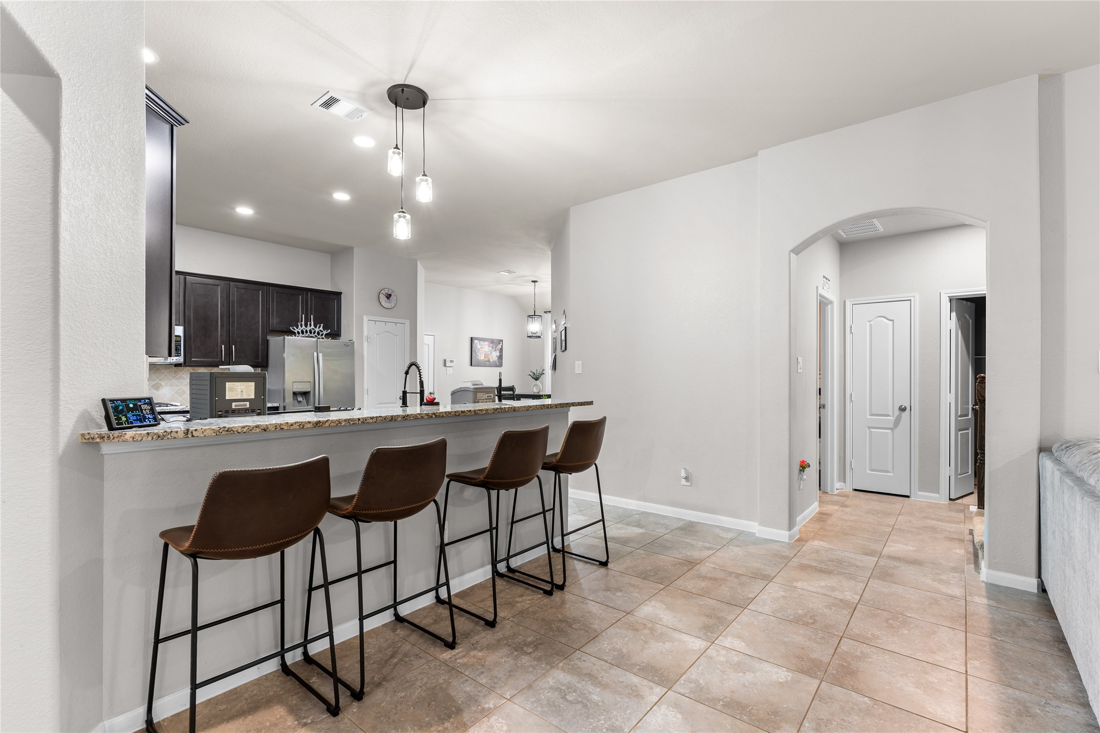 Breakfast bar with seating that opens to the heart of the home.