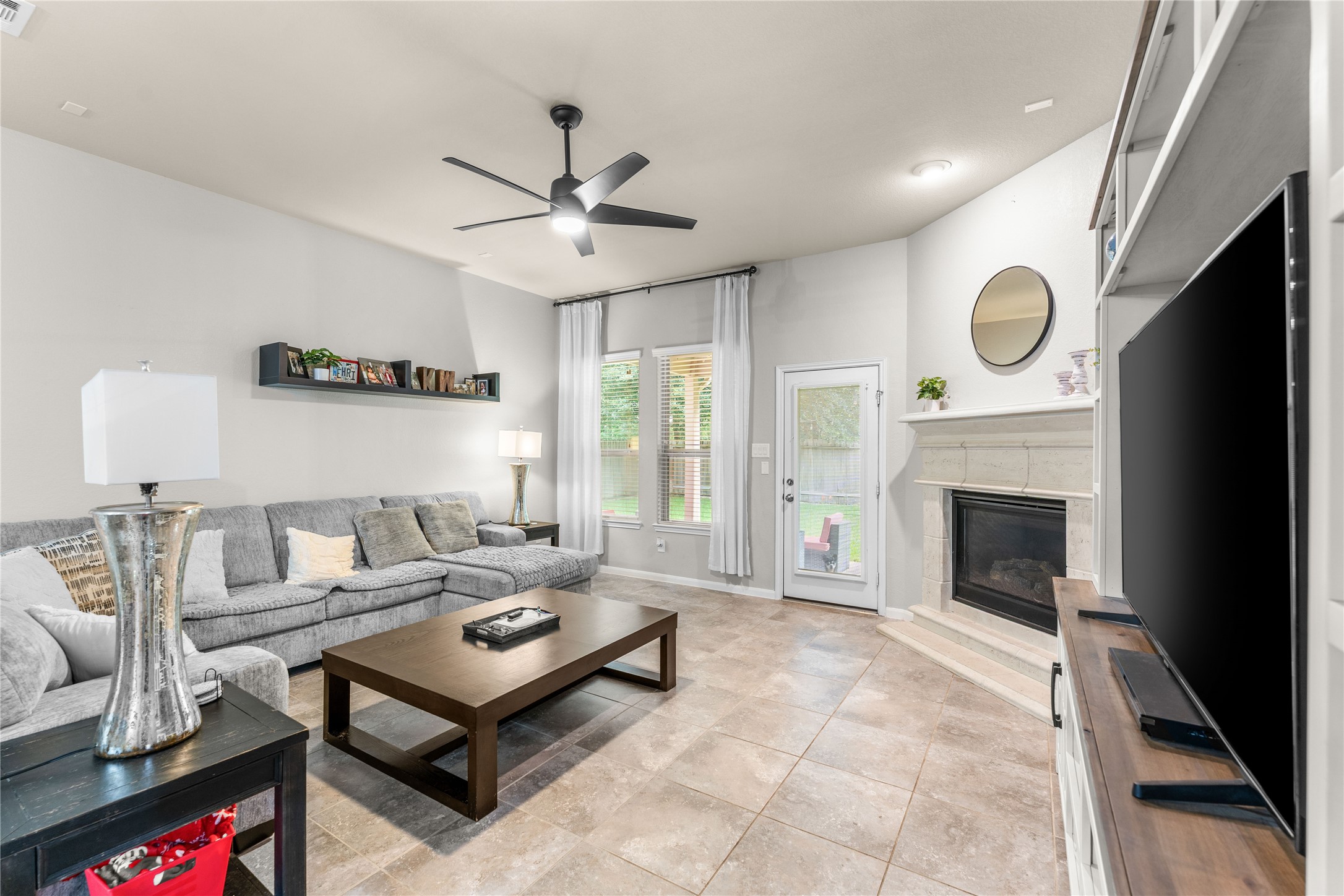 Open living area with soaring ceilings, fireplace, and comfortable flow.