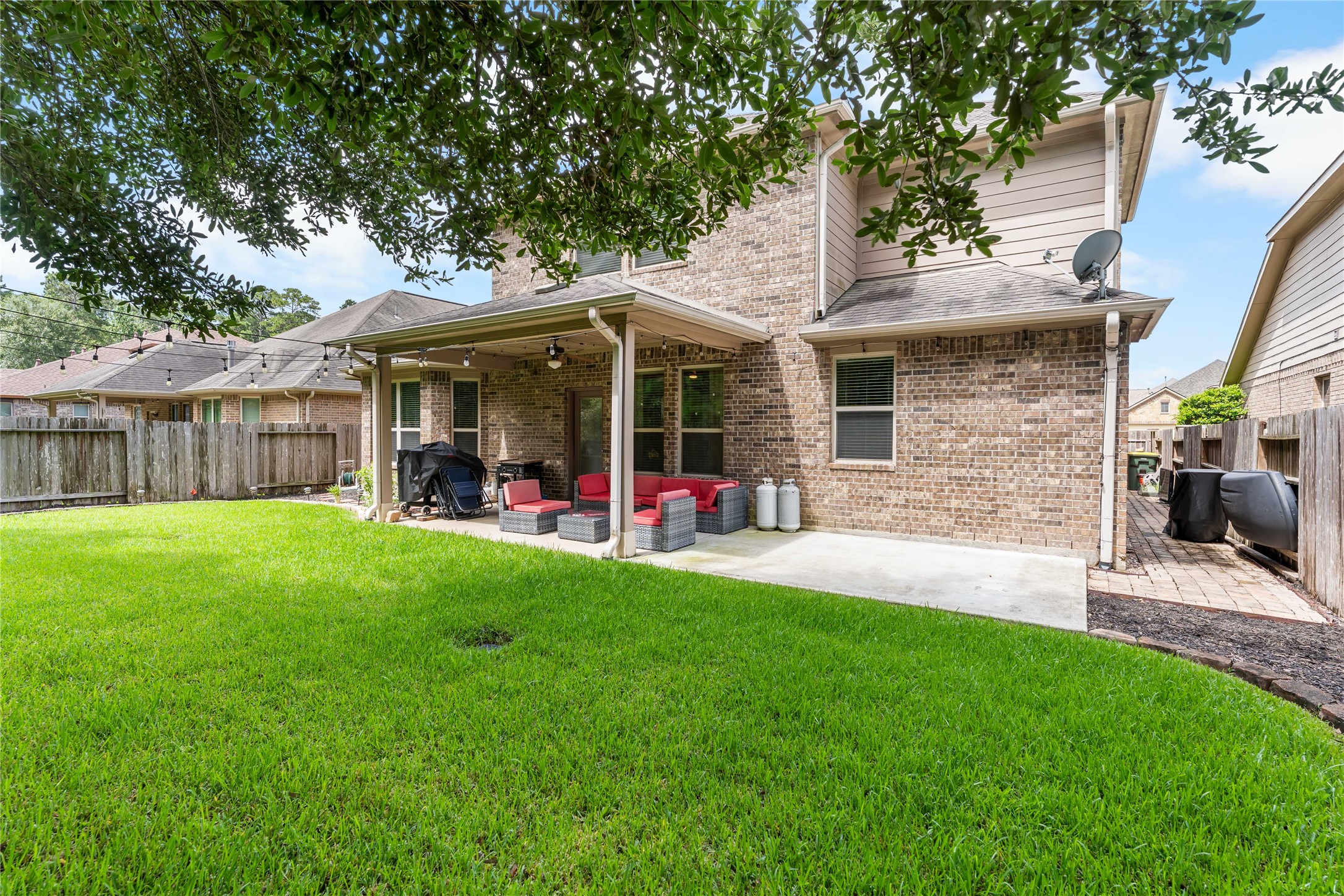 Rear exterior highlighting the two-story design and expansive lawn.