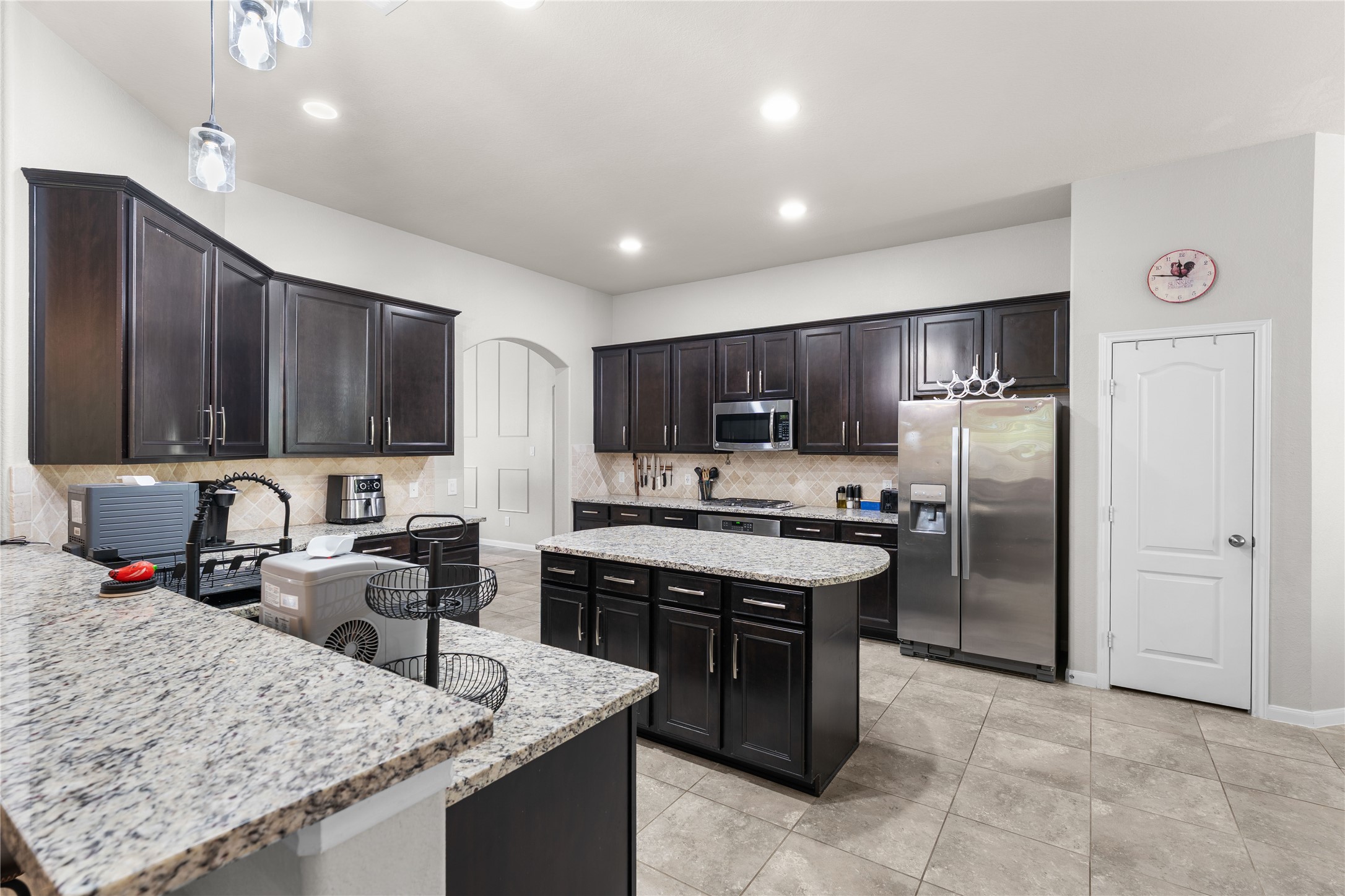 Granite island kitchen with abundant cabinetry and modern finishes.