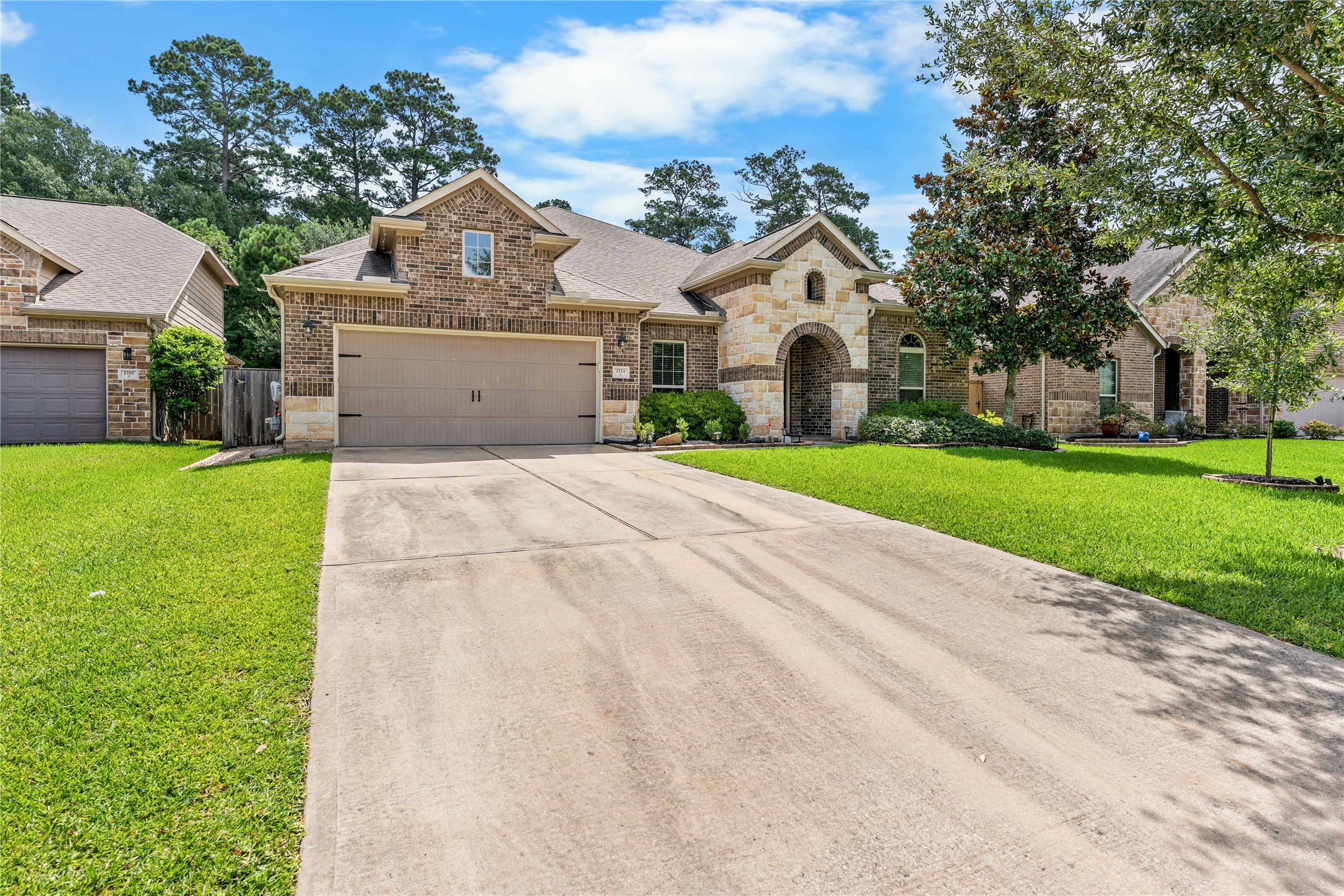 Extended driveway leading to the attached garage with attractive curb appeal.