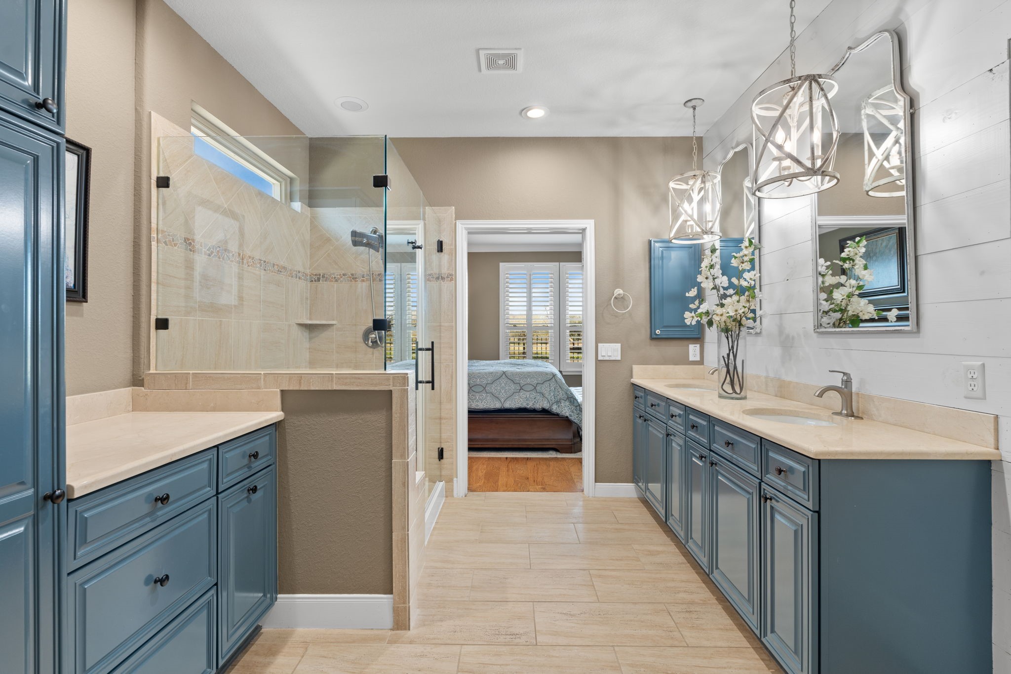 Start and end your day in an owner's bathroom designed for both relaxation and inspiration. Thoughtfully crafted for comfort, this space features a convenient medicine cabinet and stunning French blue custom-painted cabinetry. A unique pull-out trash adds both style and functionality to this elegant retreat.