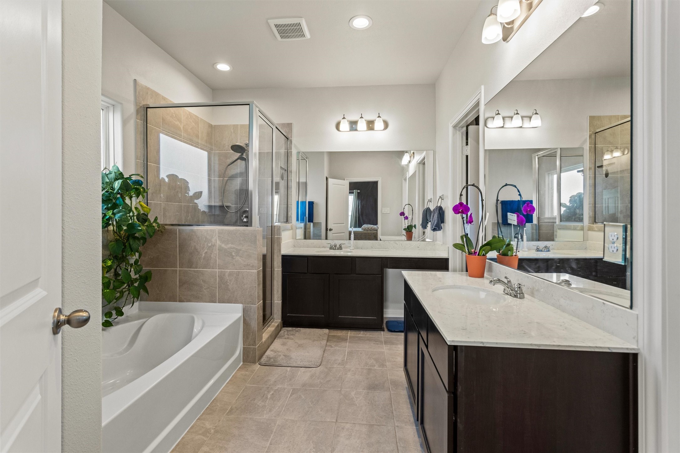 Primary en-suite bathroom with dual sinks and vanities.