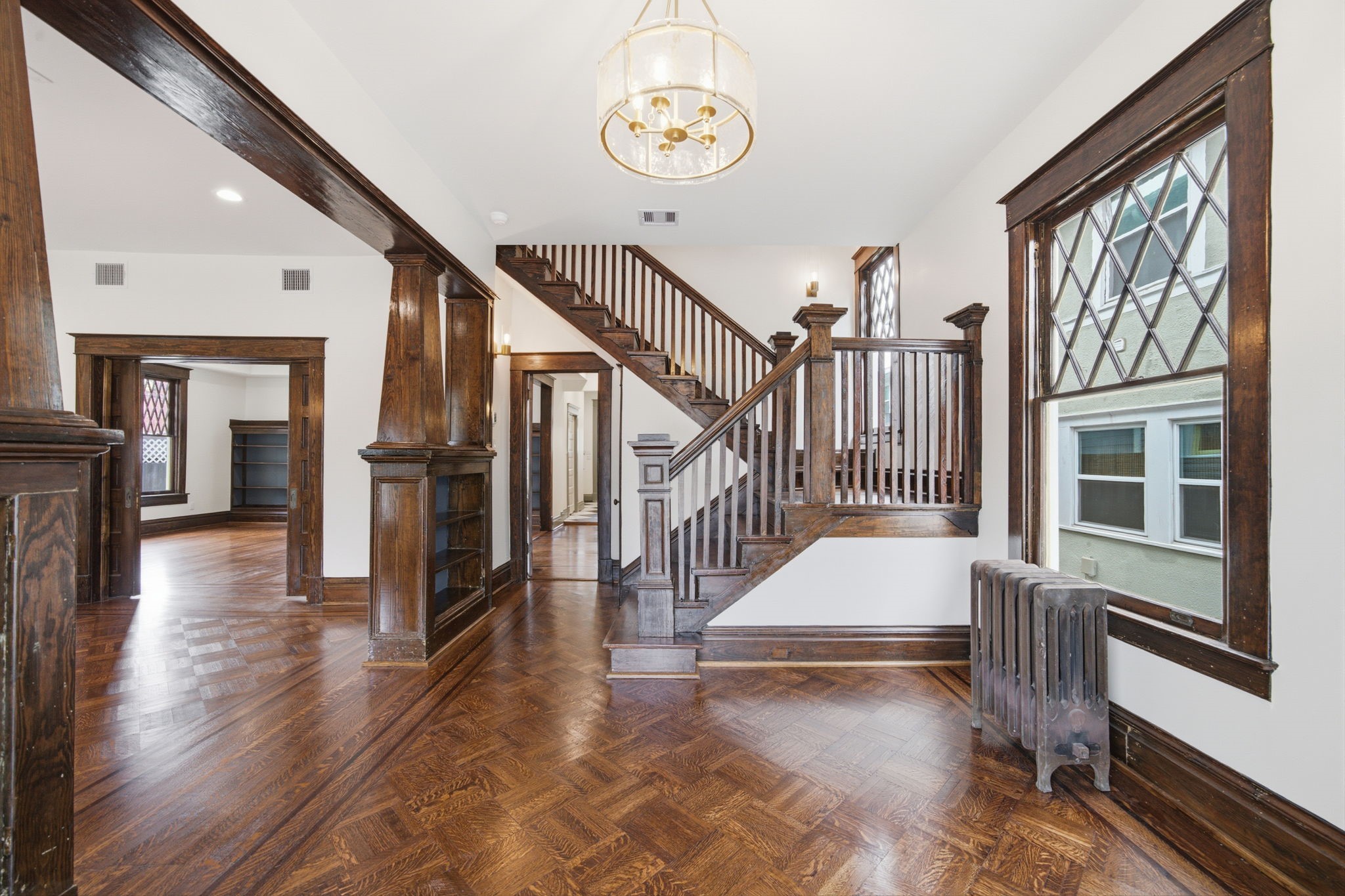 Elegant entryway leading to spacious dining area and kitchen with classic charm.