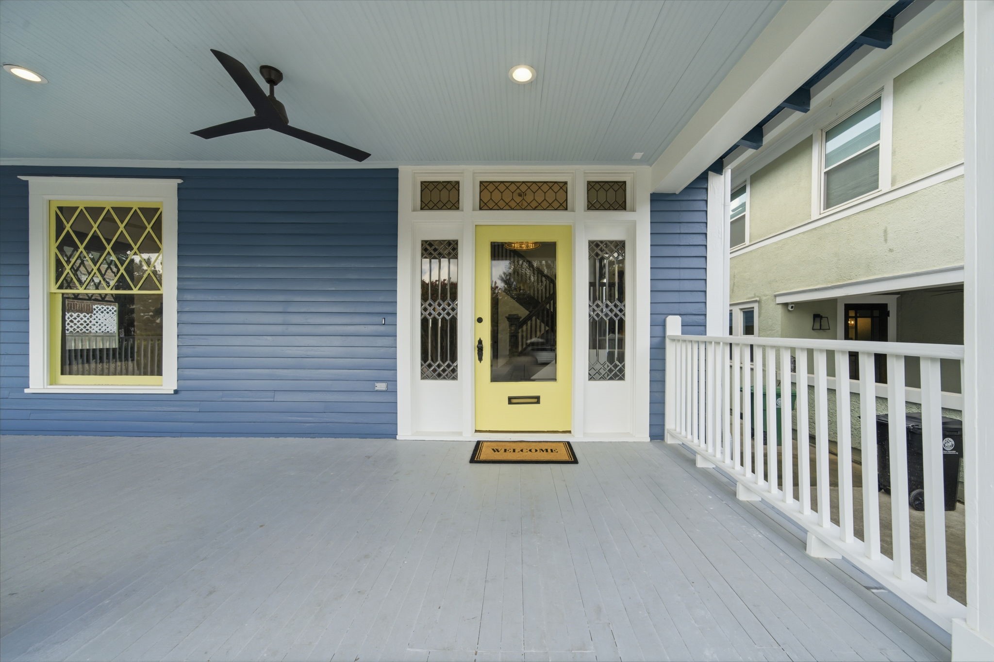 Classic wrap around front porch with original wood siding and the original front door, including the restored leaded glass detailing, perfect for relaxing afternoons.