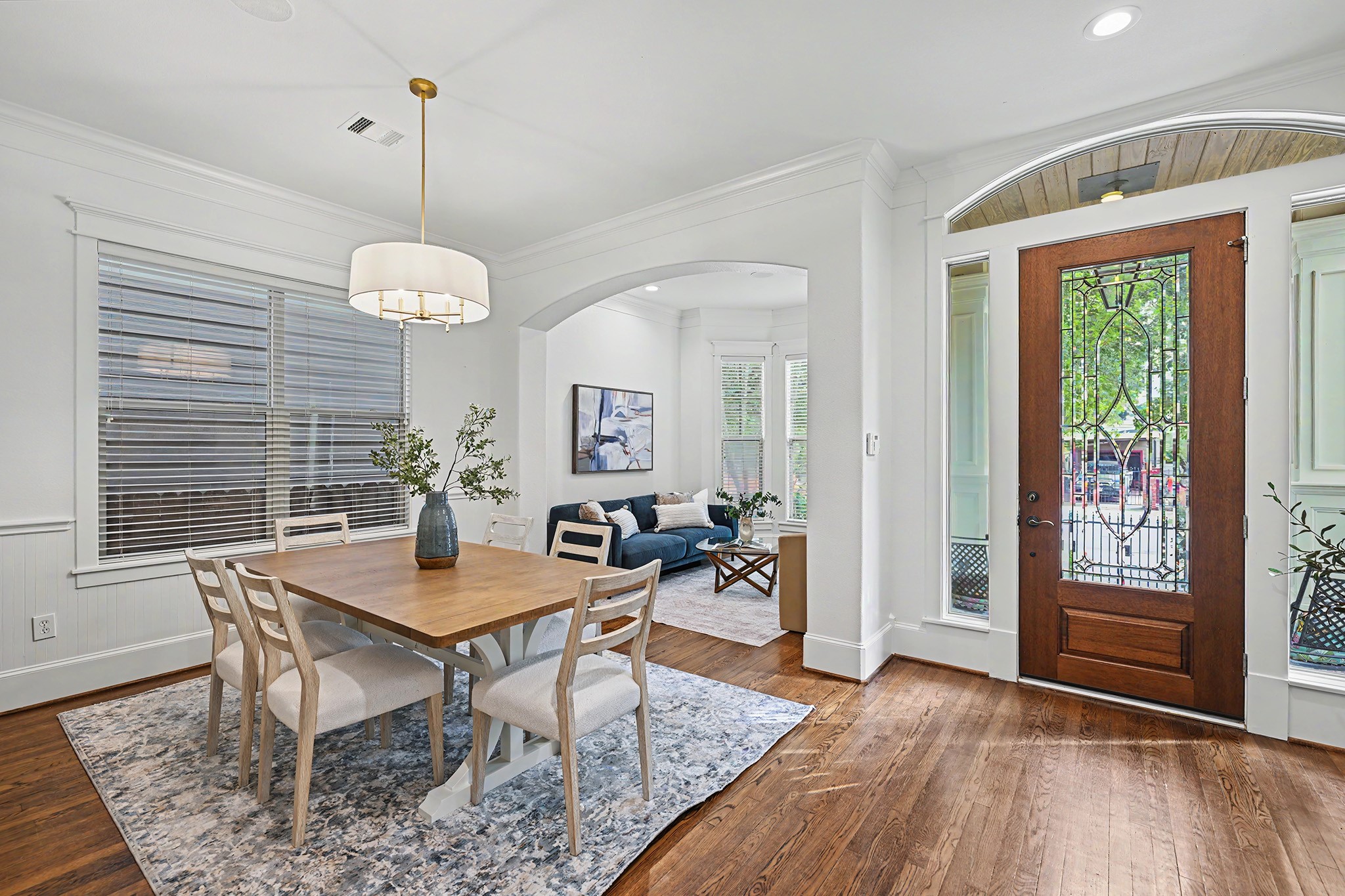 Front of home with entryway, dining room and living room. Ceiling speakers in place.