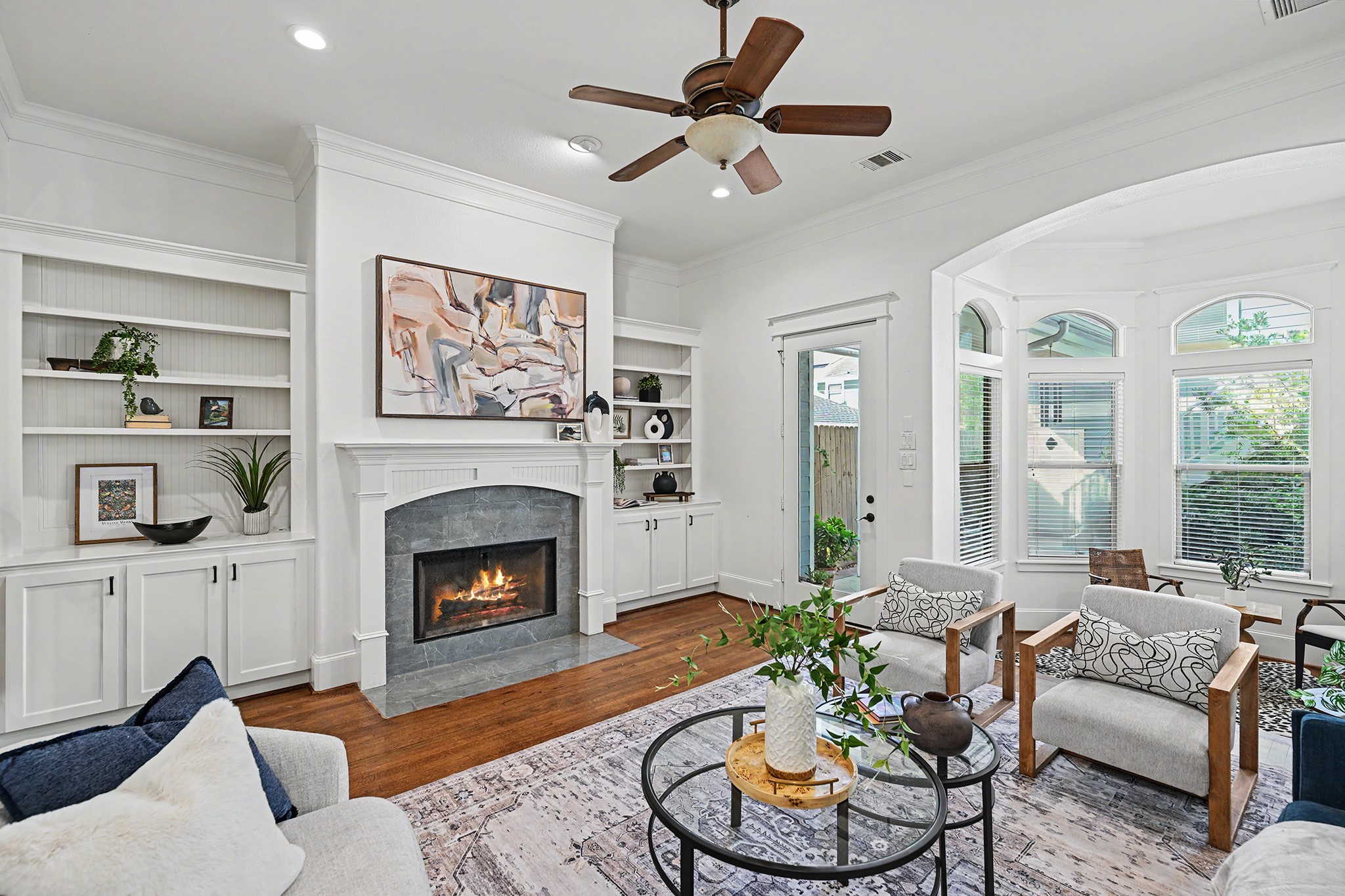 Spacious and relaxing family room area. Side storage and bookshelves flank the fireplace.