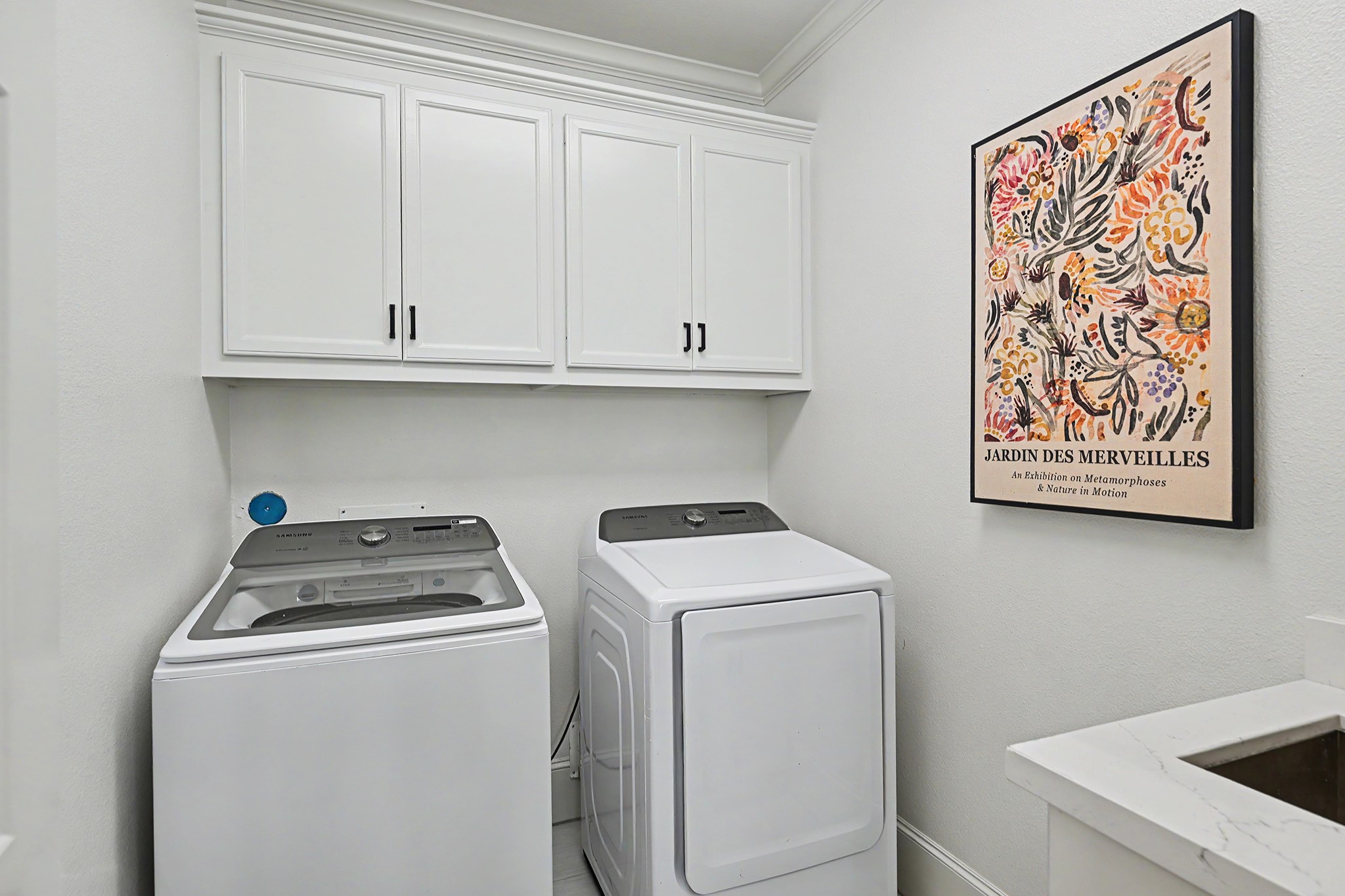 Upstairs laundry room includes a soaking sink.