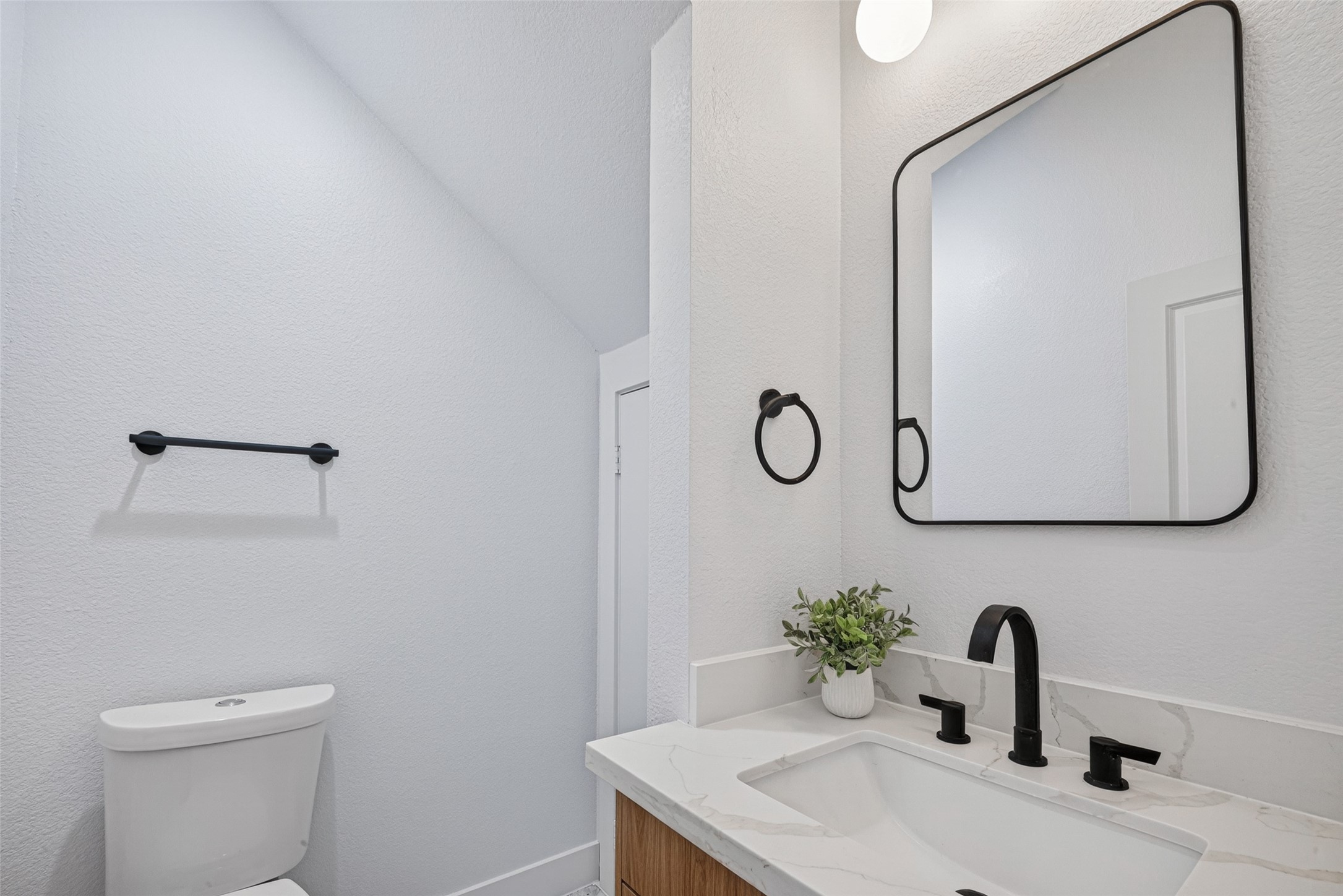 Half bath with marble flooring