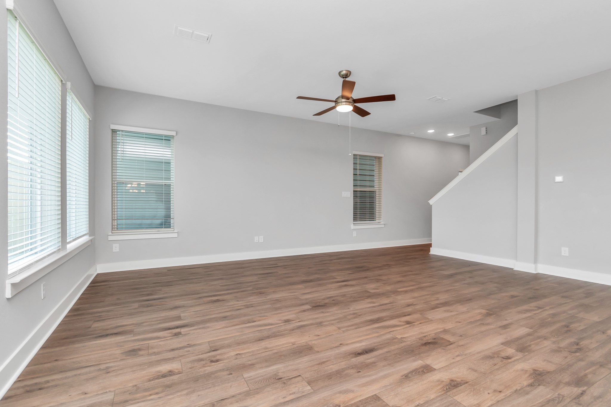 Light & Bright Living Area with Breathtaking Wood-Like Vinyl Plank Flooring.