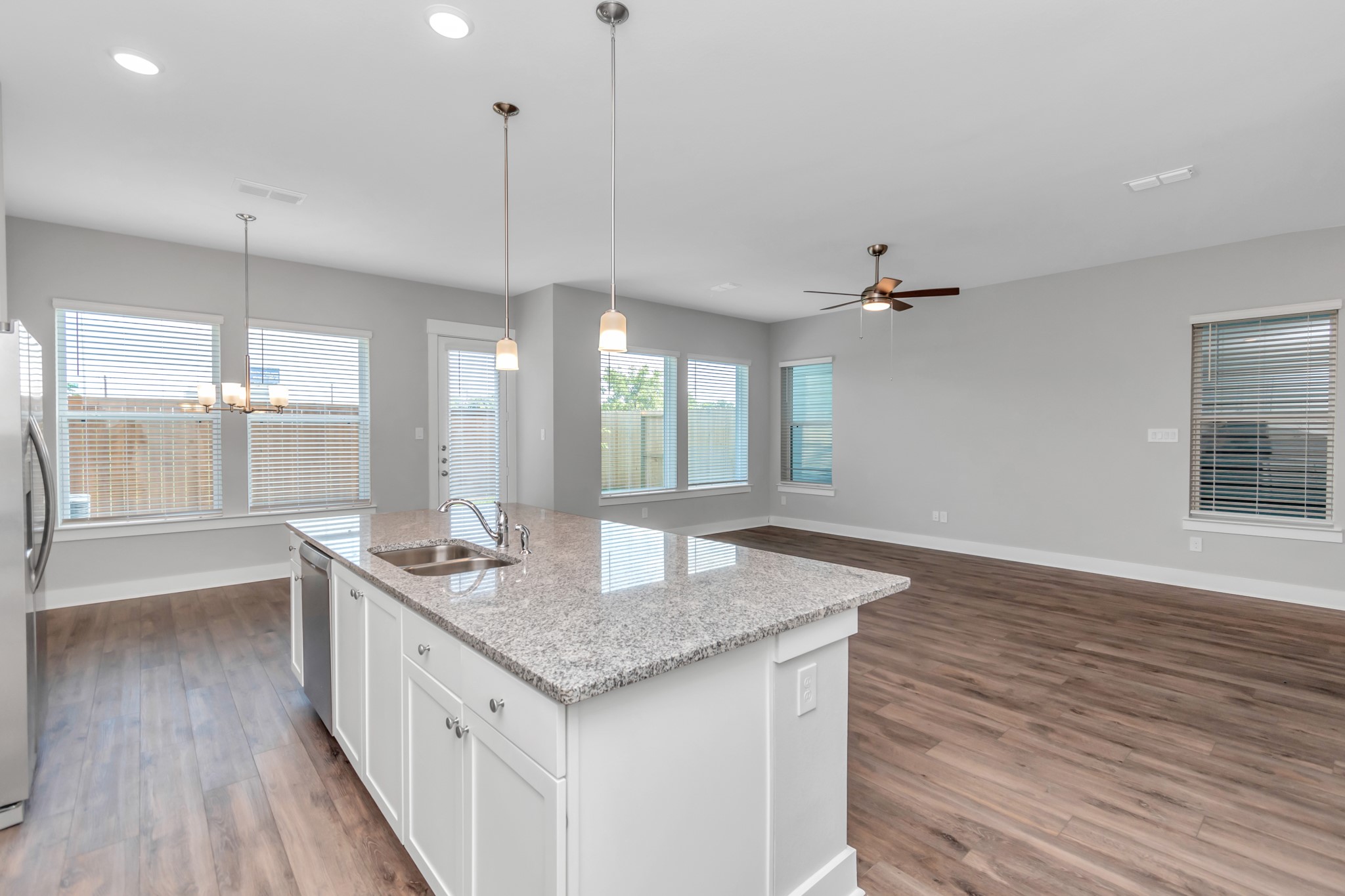 Elegant Granite Countertops & Luxurious Wood-Like Vinyl Plank Flooring.