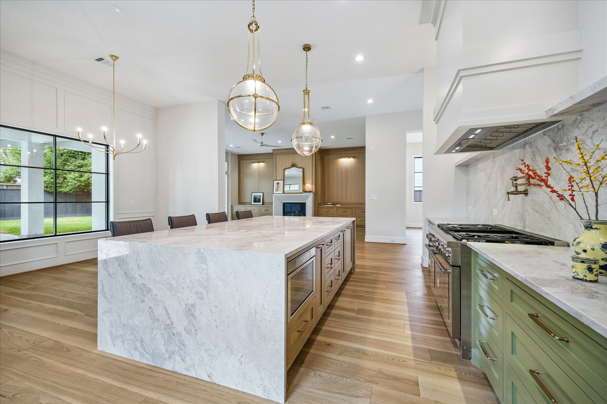 The kitchen features a stunning waterfall marble island that provides ample seating, perfect for both casual meals and entertaining. The Thermador appliance package includes a 30 panel-ready refrigerator alongside an 18 freezer, a Pro Grand 48 gas range with a griddle, an Emerald 24 panel-ready dishwasher, a 24 Micro drawer microwave, and a 24 built-in coffee machine.