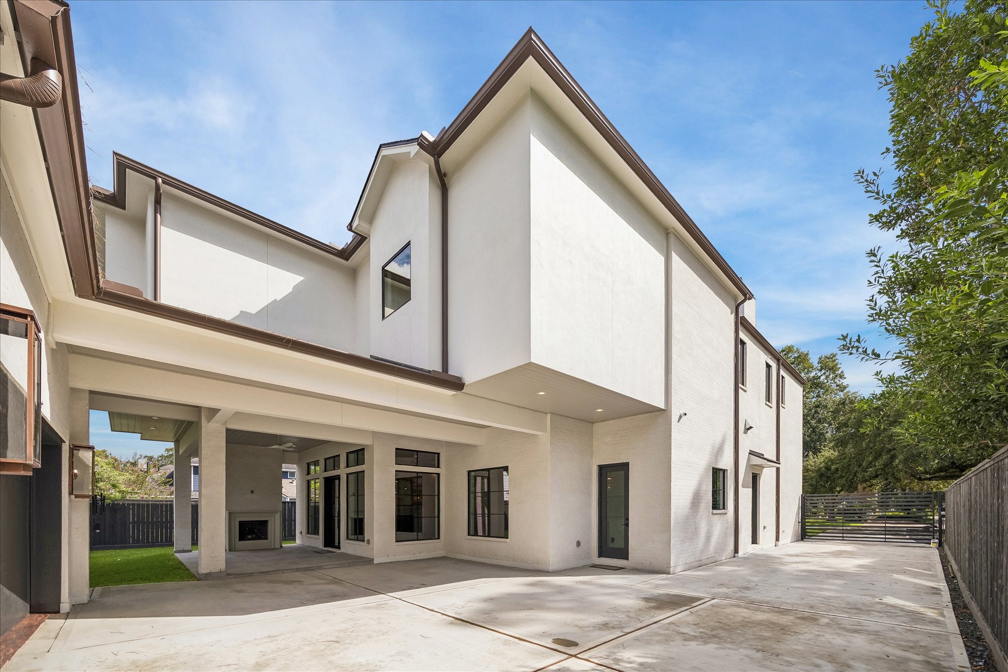 The backyard is designed for relaxation and entertainment, featuring a covered patio where the fireplace serves as a stunning focal point. This inviting area provides a perfect setting for gatherings, whether enjoying a quiet evening or hosting guests.