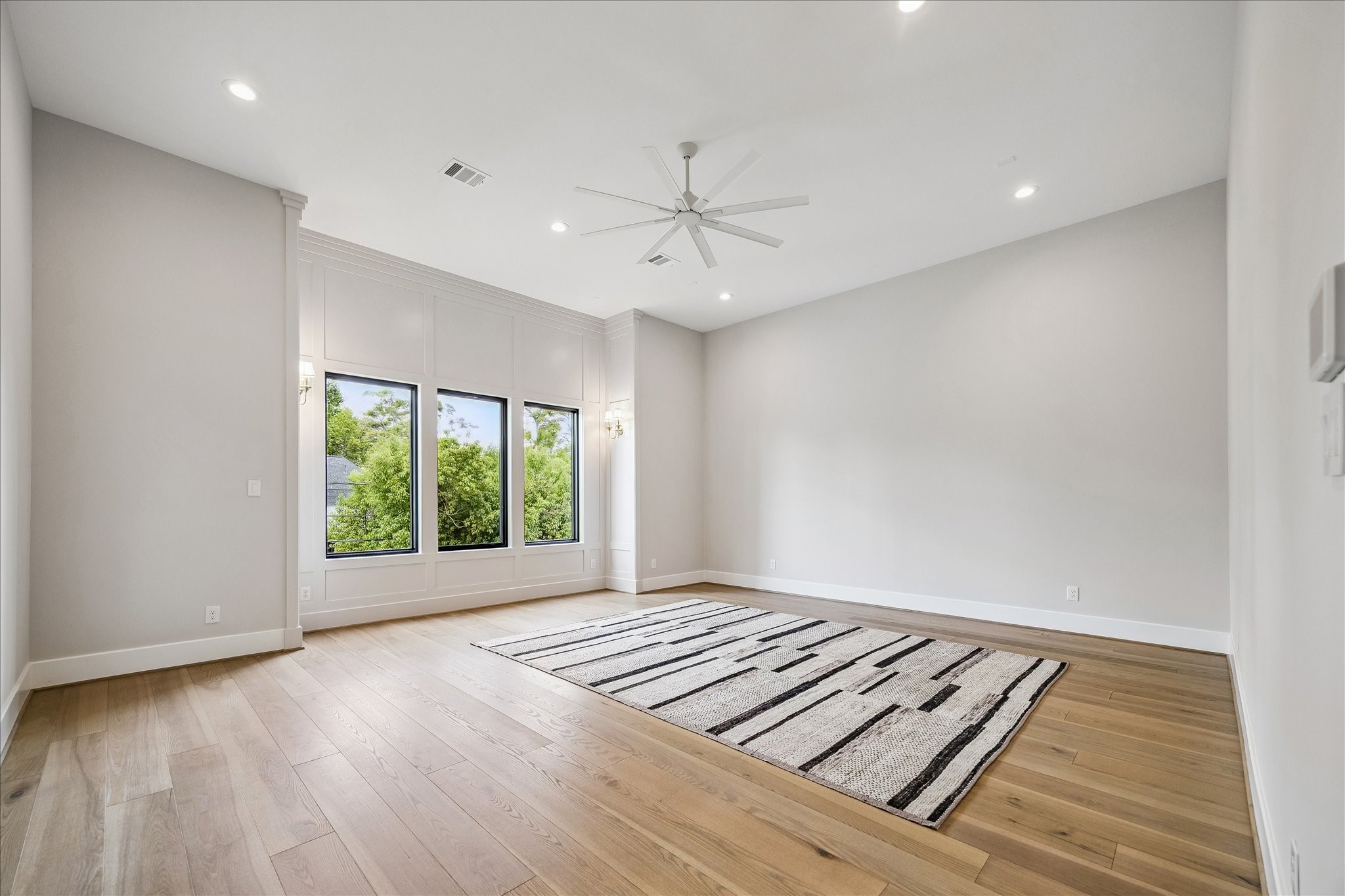 The primary suite serves as a retreat with high ceilings and spacious sitting area.
