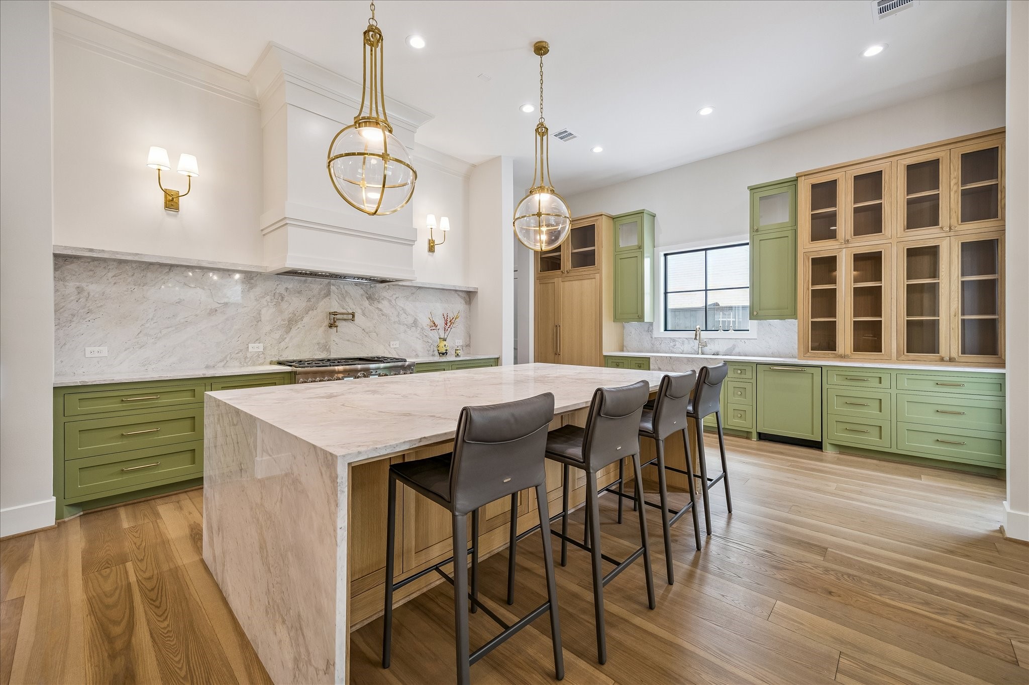 Chefs kitchen offers a Montebello stone island and a full Thermador suite with a 48-inch Pro Grand range, panel-ready columns, and a built-in coffee system.