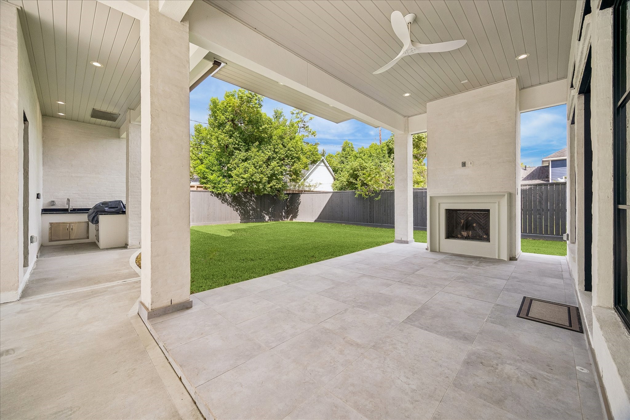 The full summer kitchen is a standout feature, equipped with an Artisan 60,000 BTU 32-inch gas grill, Alfresco 32-inch double doors, and a sink, making outdoor cooking both convenient and enjoyable. This well-appointed space is ideal for preparing meals and dining al fresco.
