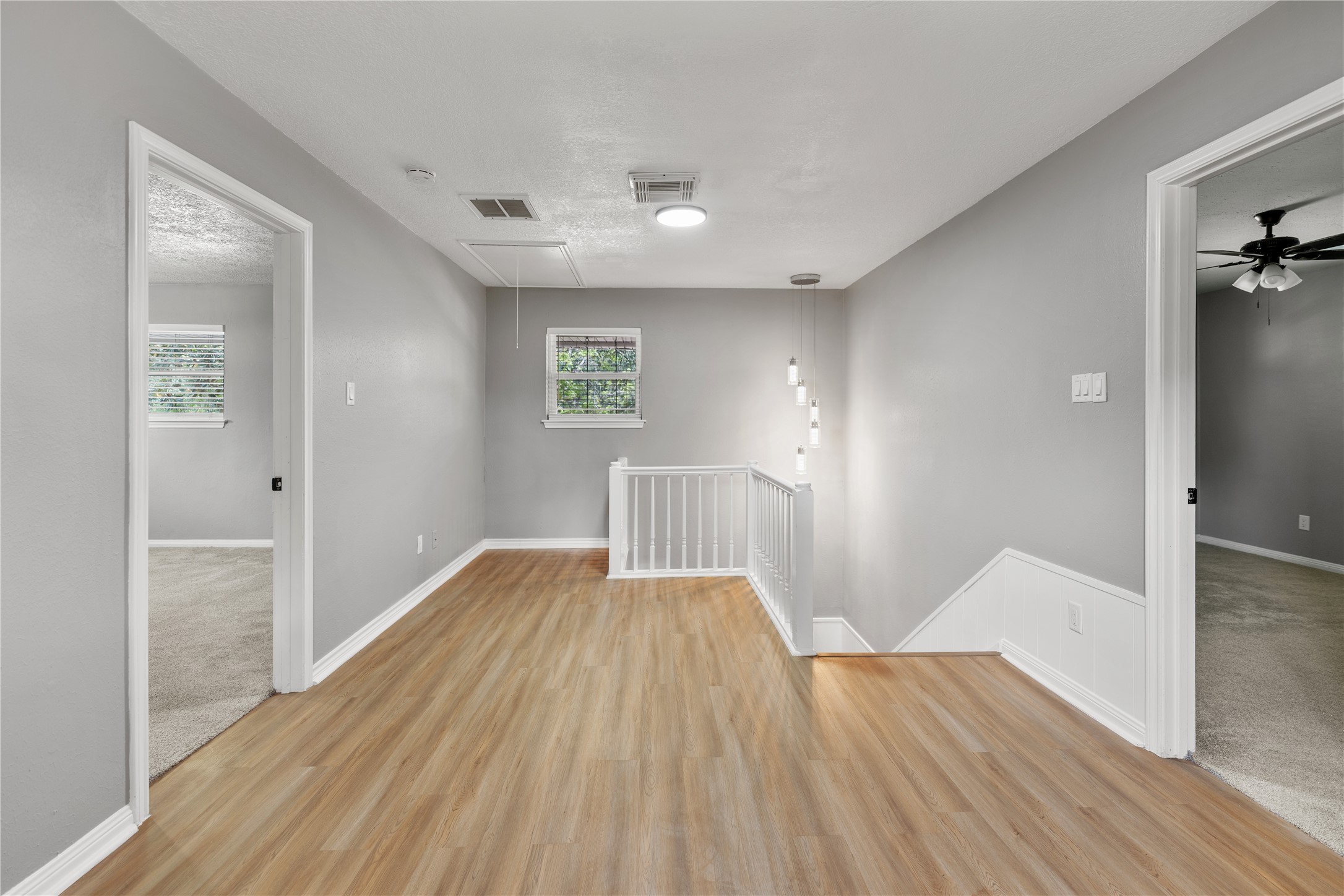 The second floor features another ample flex space, ideal for a game room or family living.
The statement lighting fixture over the staircase brings a touch of modern sophistication.