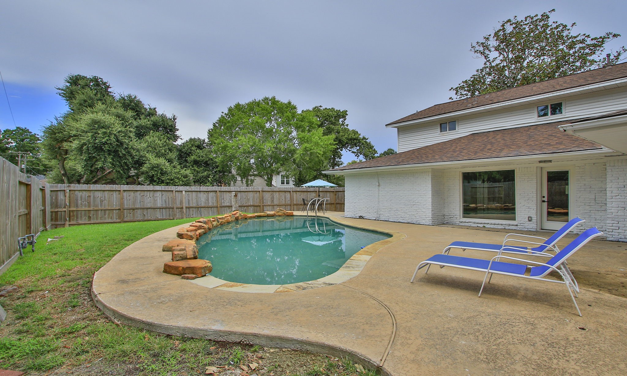 Alternate view of the pool and the backyard.