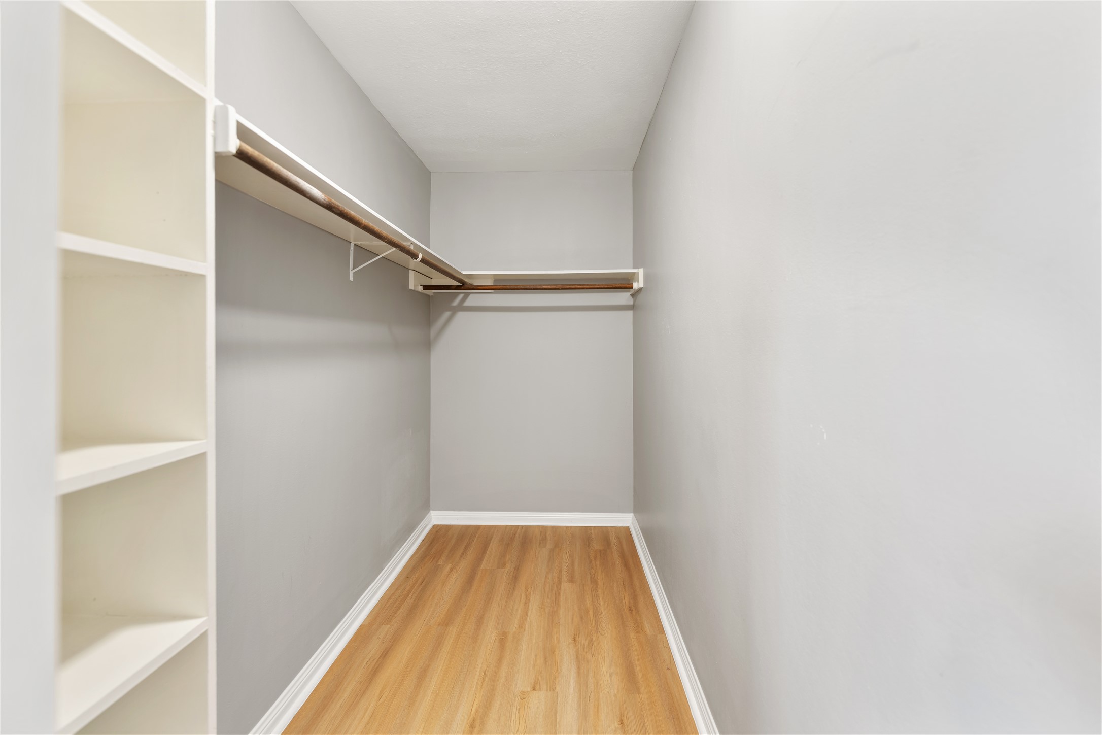 The main bedroom walk-in closet with wooden floors and plenty of space.