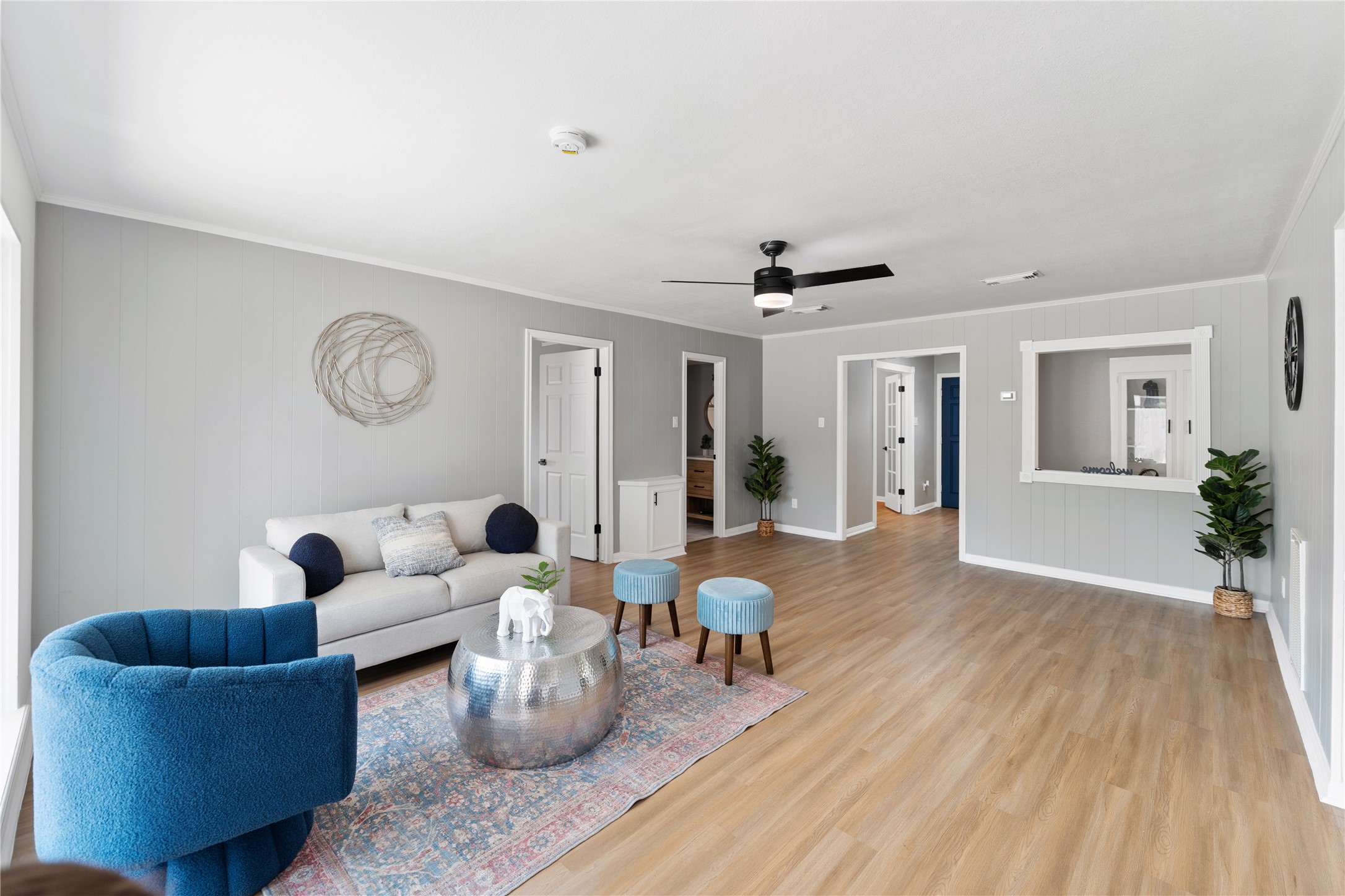 Alternate view of the living room, featuring a modern ceiling fan and plenty of space for entertainment or relaxation.