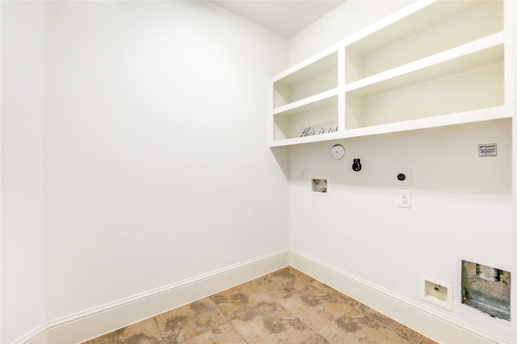Ample utility room with built-in shelves