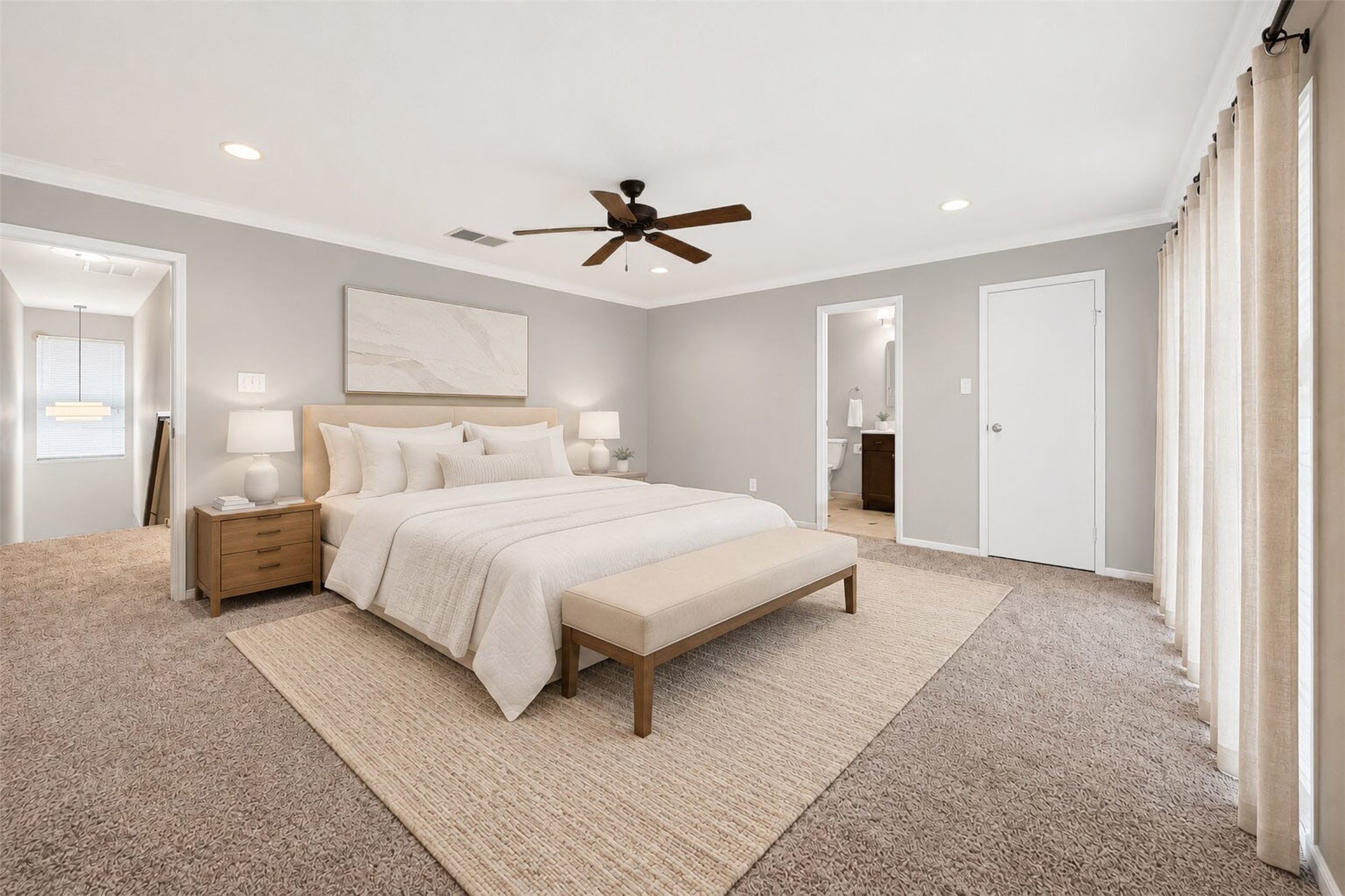 Virtually staged with a dressed bed, bench, and nightstands, this spacious second bedroom includes direct access to its own bathroom  ideal for guests or a roommate setup.