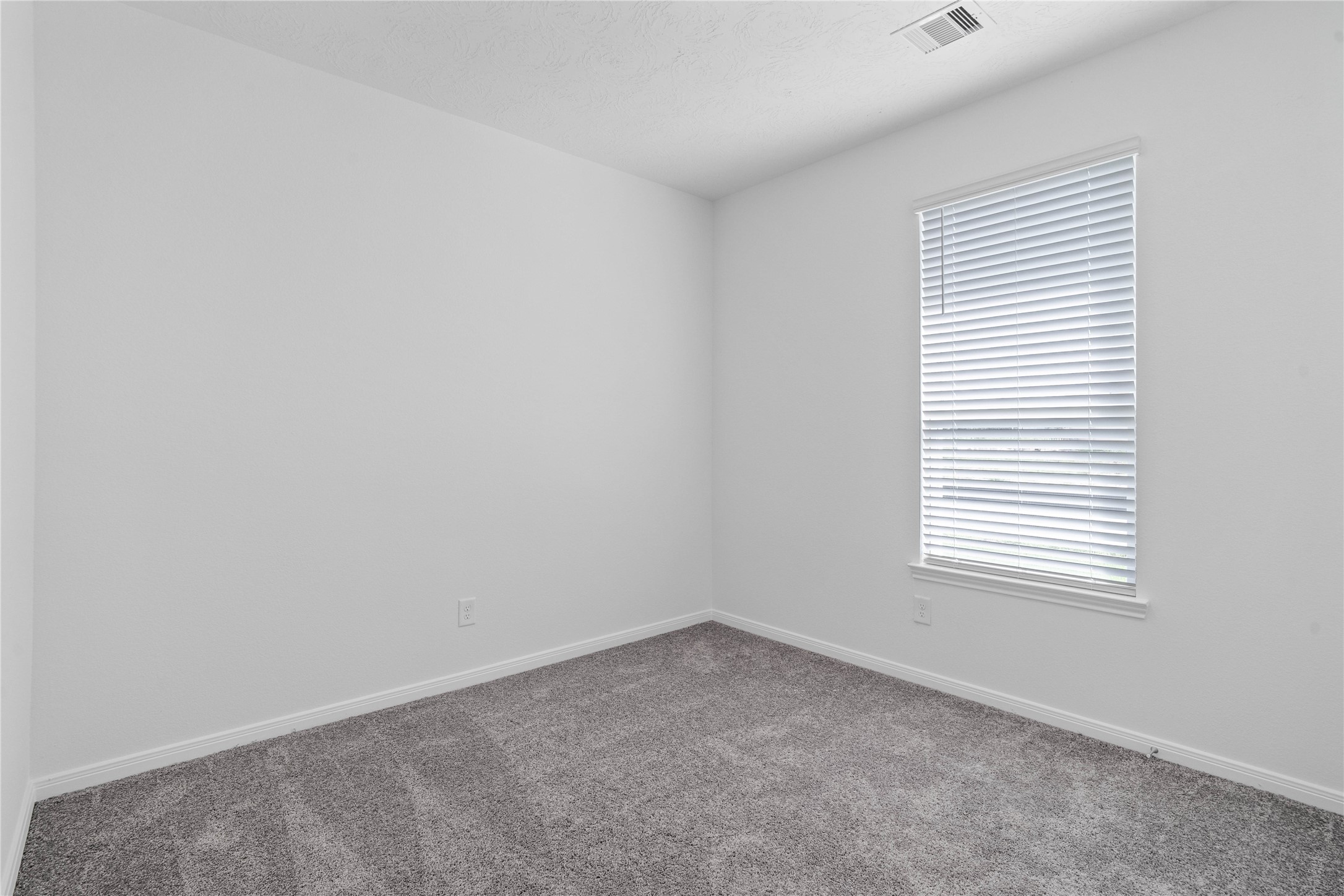 Tucked peacefully in the front of the home is this secondary bedroom. It features plush carpet flooring, large window with blinds, and closet space. Tucked peacefully in the front of the home is this secondary bedroom. It features plush carpet flooring, large window with blinds, and closet space.