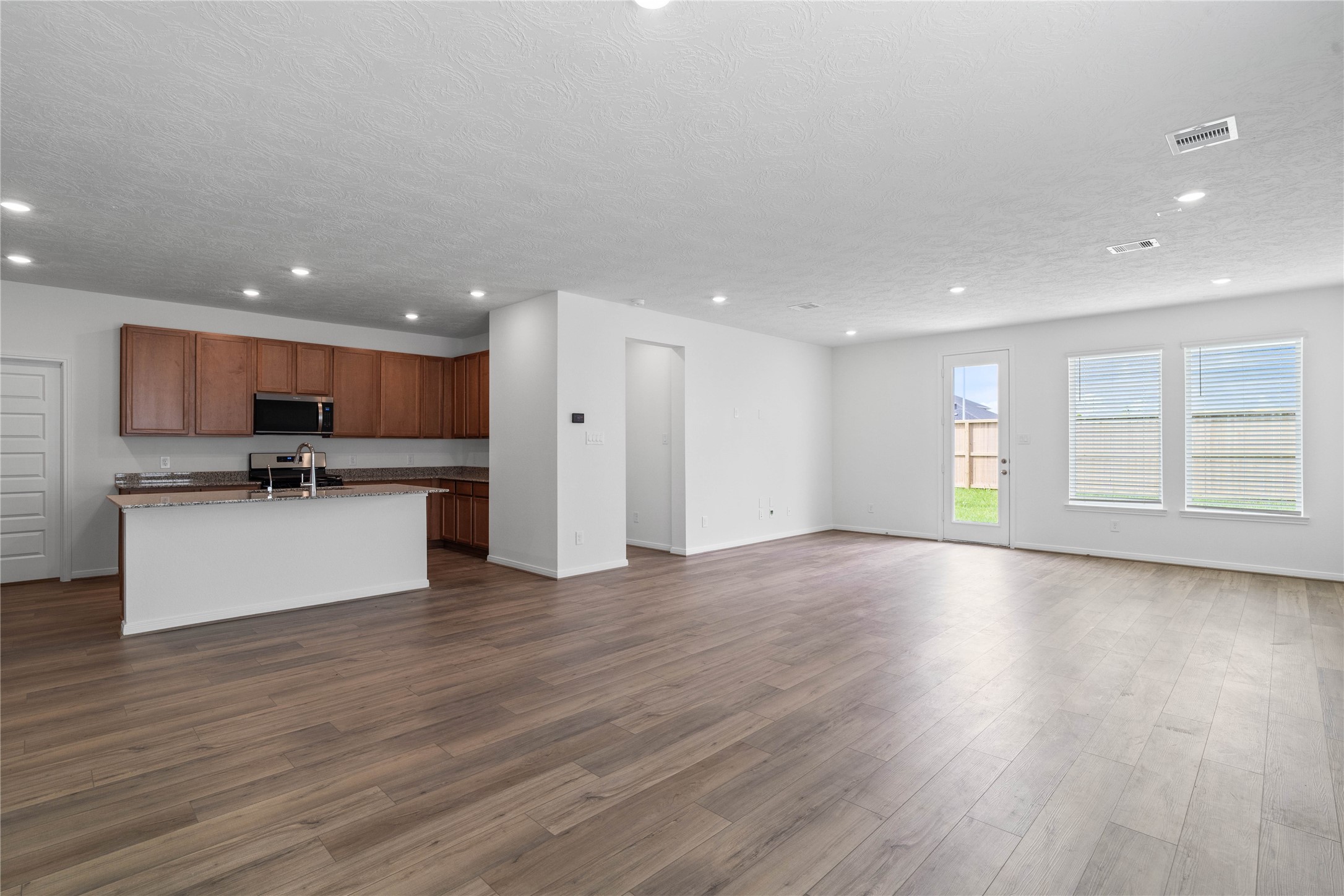 Stunning open-concept design seamlessly connecting the living, dining, and kitchen areasperfect for both everyday living and entertaining!