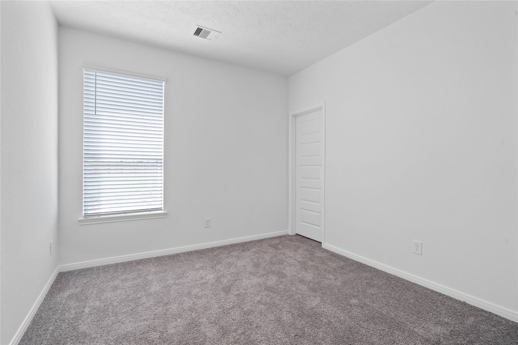 The spacious Den offers cozy carpet flooring, a large window, and an ample sized closet. This versatile den significantly expands the homes footprint, providing valuable added living space.