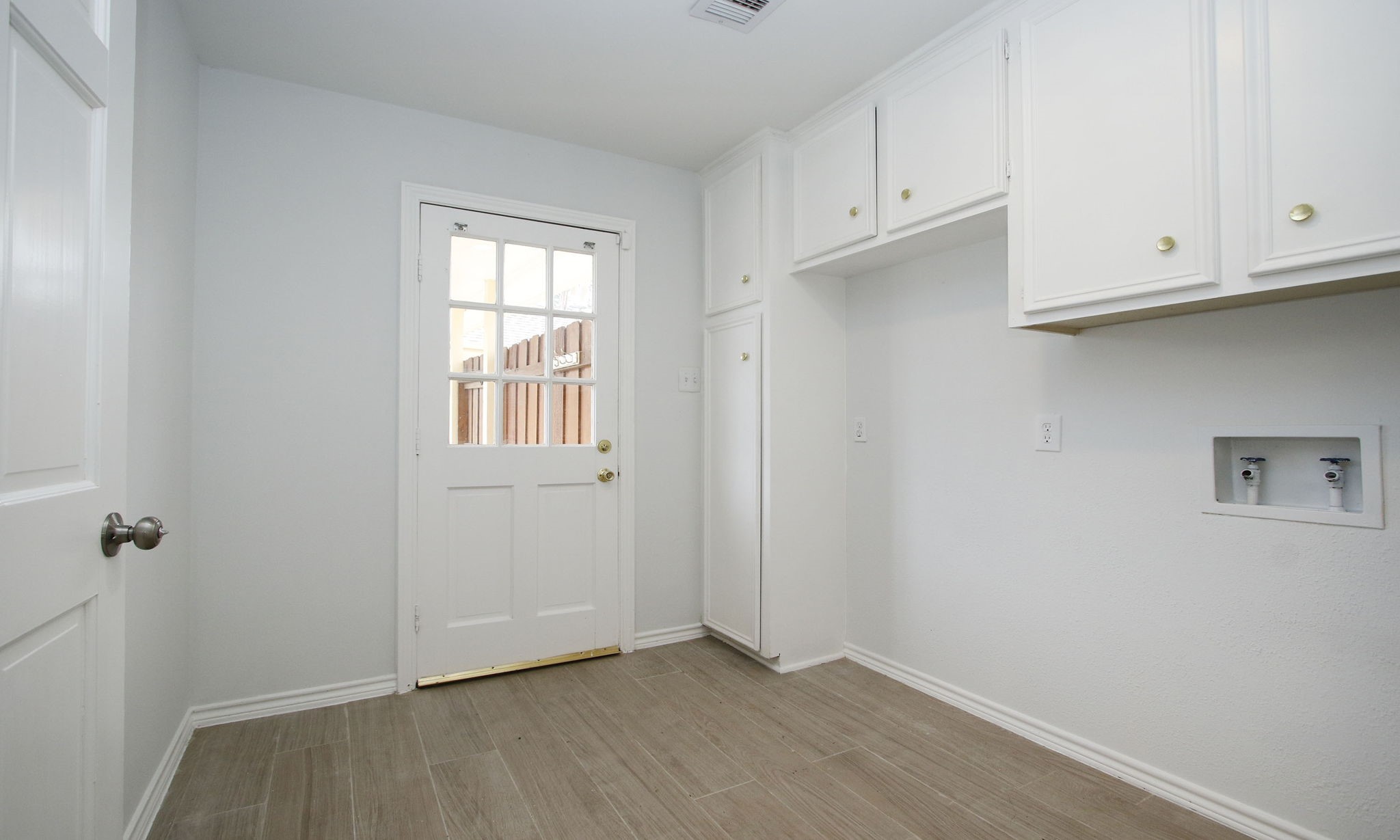 Downstairs laundry with attached half bath