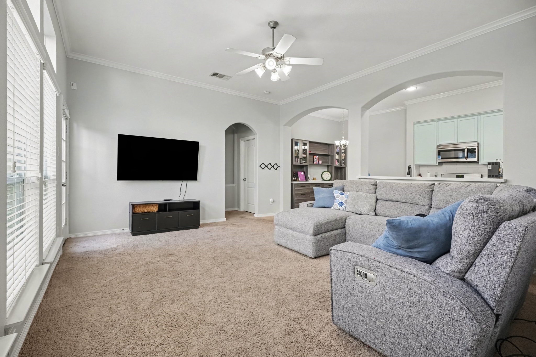 The living room features high ceilings and an open concept.