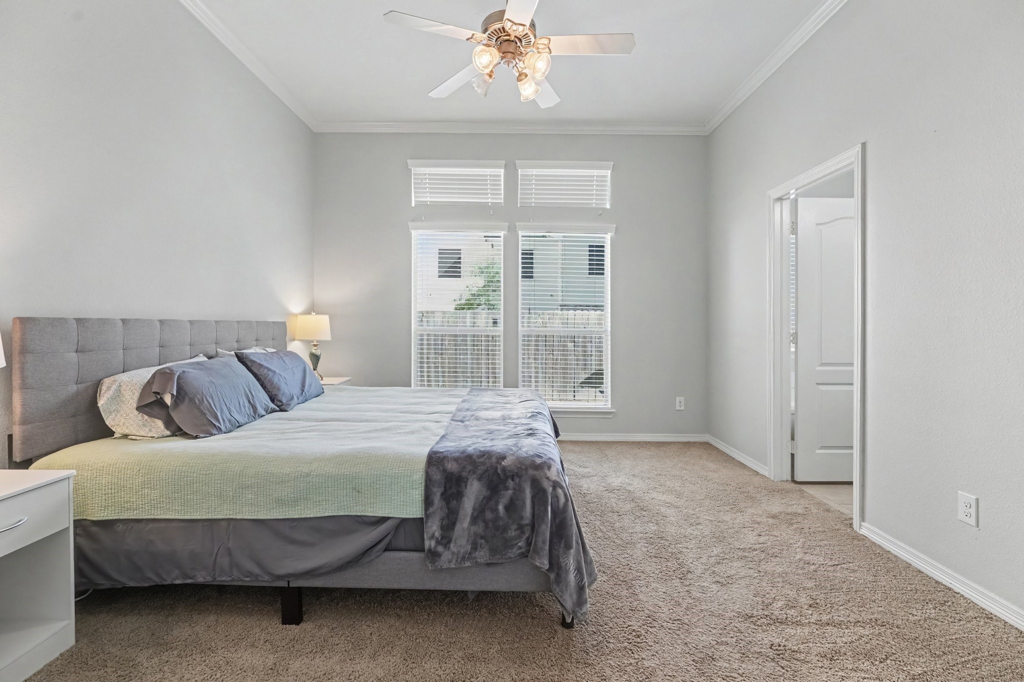 Spacious first floor primary bedroom featuring an en-suite bathroom and walk in closet.