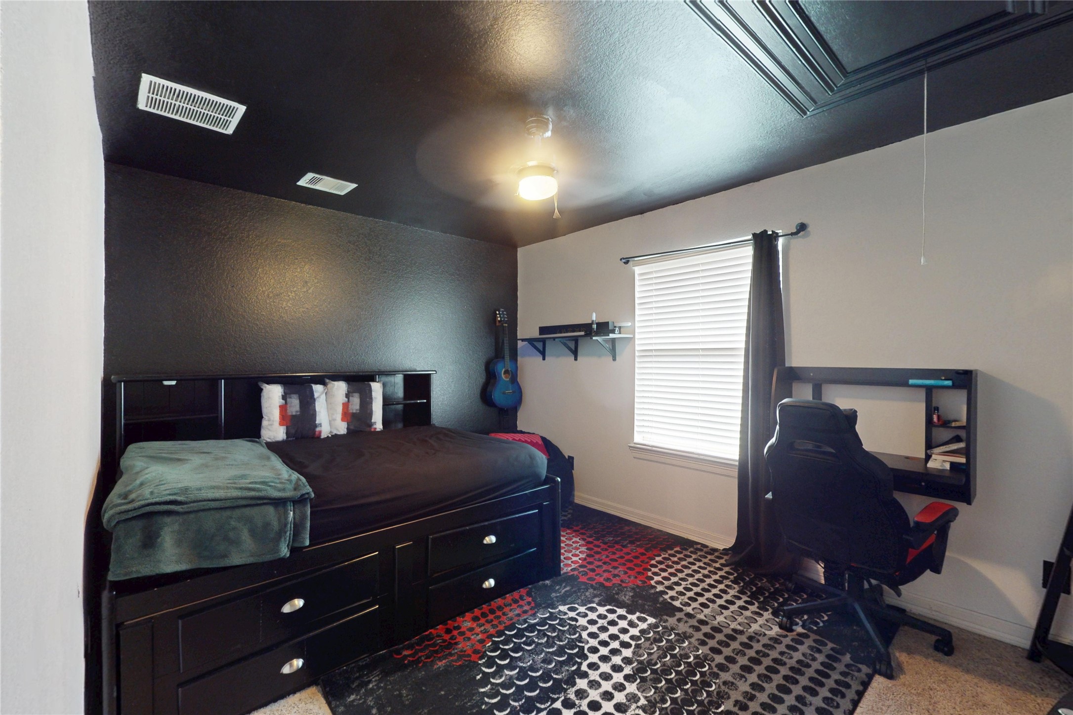 Secondary bedroom with built-in storage bed and desk area