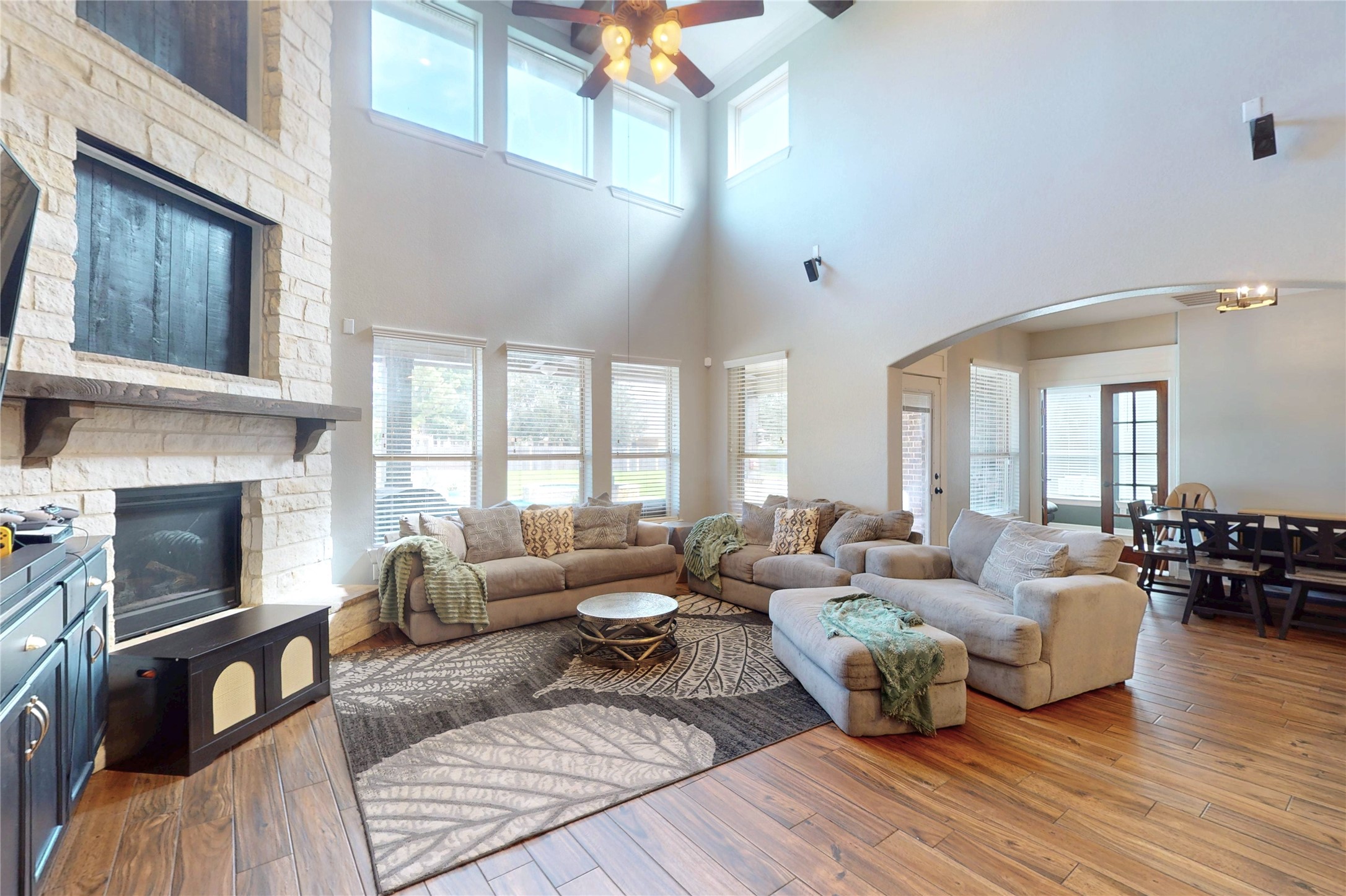 Two-story living room with floor-to-ceiling stone fireplace