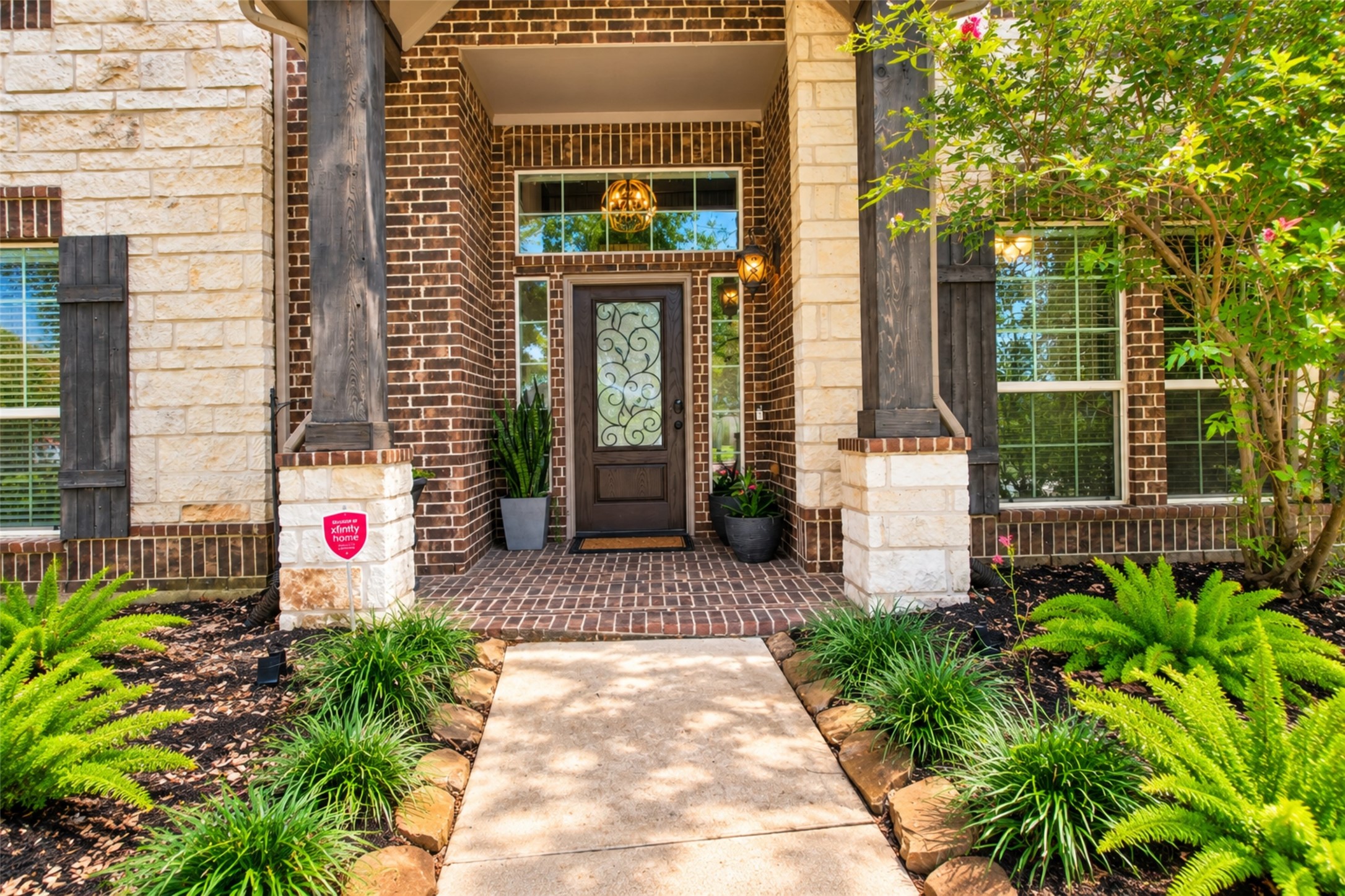 Covered front entry with stone columns and leaded-glass door Covered front entry with stone columns and leaded-glass door