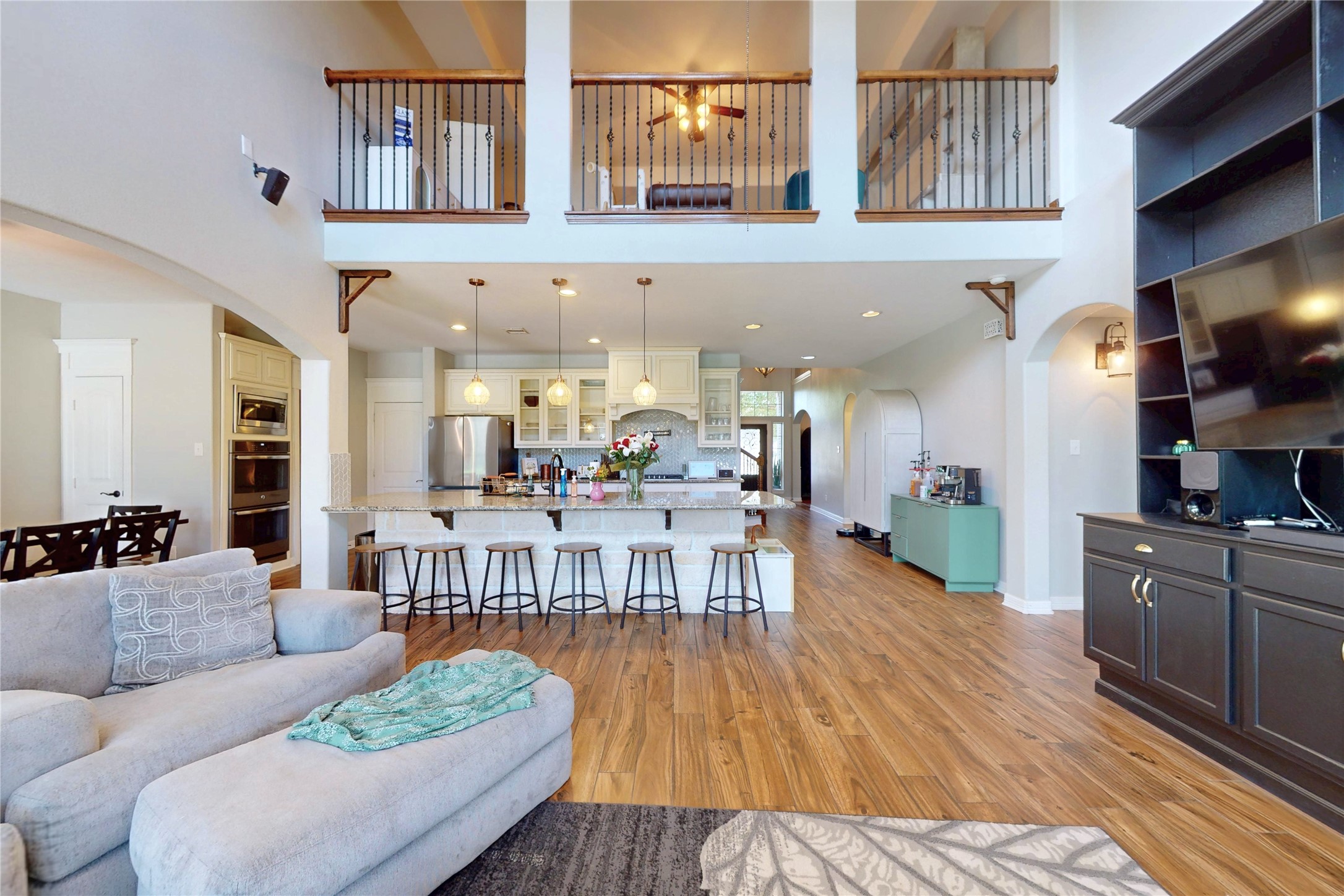 Living room open to the kitchen, upstairs landing above